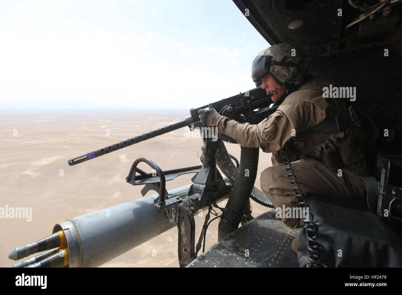 Corporal Andrew Harris, a UH-1Y Huey crew chief with Marine Light Attack Helicopter Squadron 369, and a Highland, Illinois, native, performs a weapons check before an aerial assault support mission for ground convoys in Helmand province, Afghanistan, May 3, 2014. Before the last Marines and sailors of Forward Operating Bases Nolay and Sabit Qadam convoyed out of northern Helmand to return to Camp Leatherneck for the final time, the “Gunfighters” of HMLA-369 and “Heavyweights” of Marine Heavy Helicopter Squadron 466 provided overwatch for returning vehicle convoys as well as retrograde support. Stock Photo
