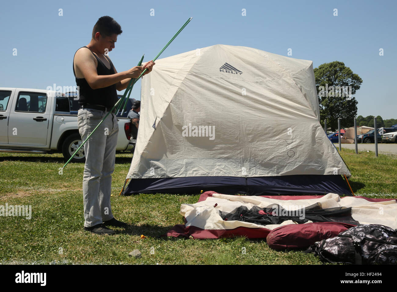 Pfc. David PiñaHuitzil puts his tent together May 2 outside of the Monster Energy's Carolina Rebellion. More than 20 Marines and Sailors with the Single Marine Program at Marine Corps Air Station Cherry Point, N.C. we able to view bands like Five Finger Death Punch and Avenged Sevenfold. PiñaHuitzil is an adminstrative clerk with Headquarters and Headquarters Squadron. Marines, Sailors rock out at Carolina Rebellion 140504-M-FR159-009 Stock Photo