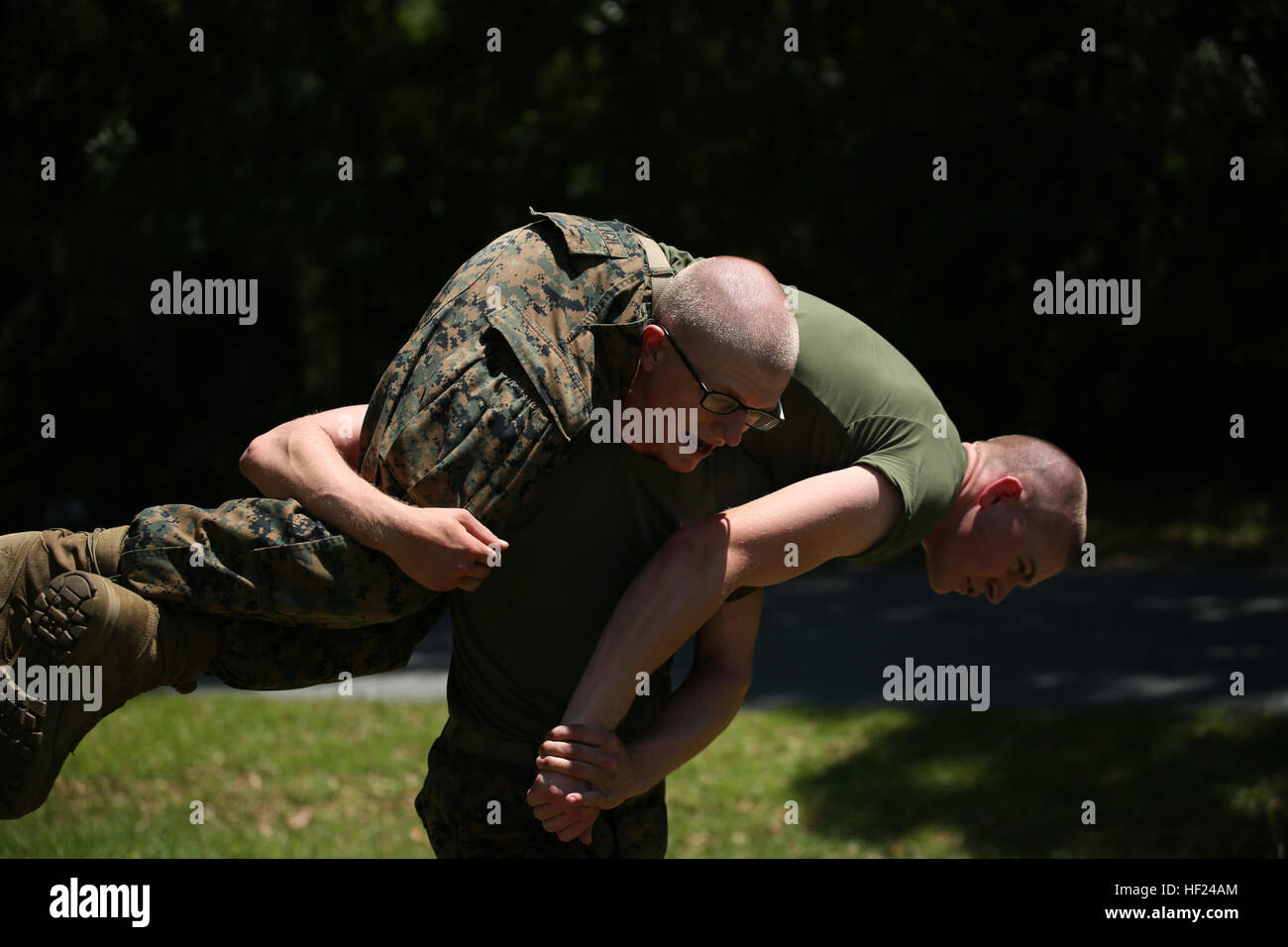 Rct. John McDonald carries Rct. Nicholas Shadlich, both with Platoon 1034, Alpha Company, 1st Recruit Training Battalion, during a developmental exercise session May 5, 2014, on Parris Island, S.C. The recruits completed a short circuit course that included pushups and buddy drags and carries. The session is part of the Developmental Exercise Program, which aims to supplement recruits’ physical training and further their fitness. McDonald, a 19-year-old from Falmouth, Ky., and Shadlich a 19-year-old from Ocala, Fla., are scheduled to graduate May 30, 2014. Parris Island has been the site of Ma Stock Photo