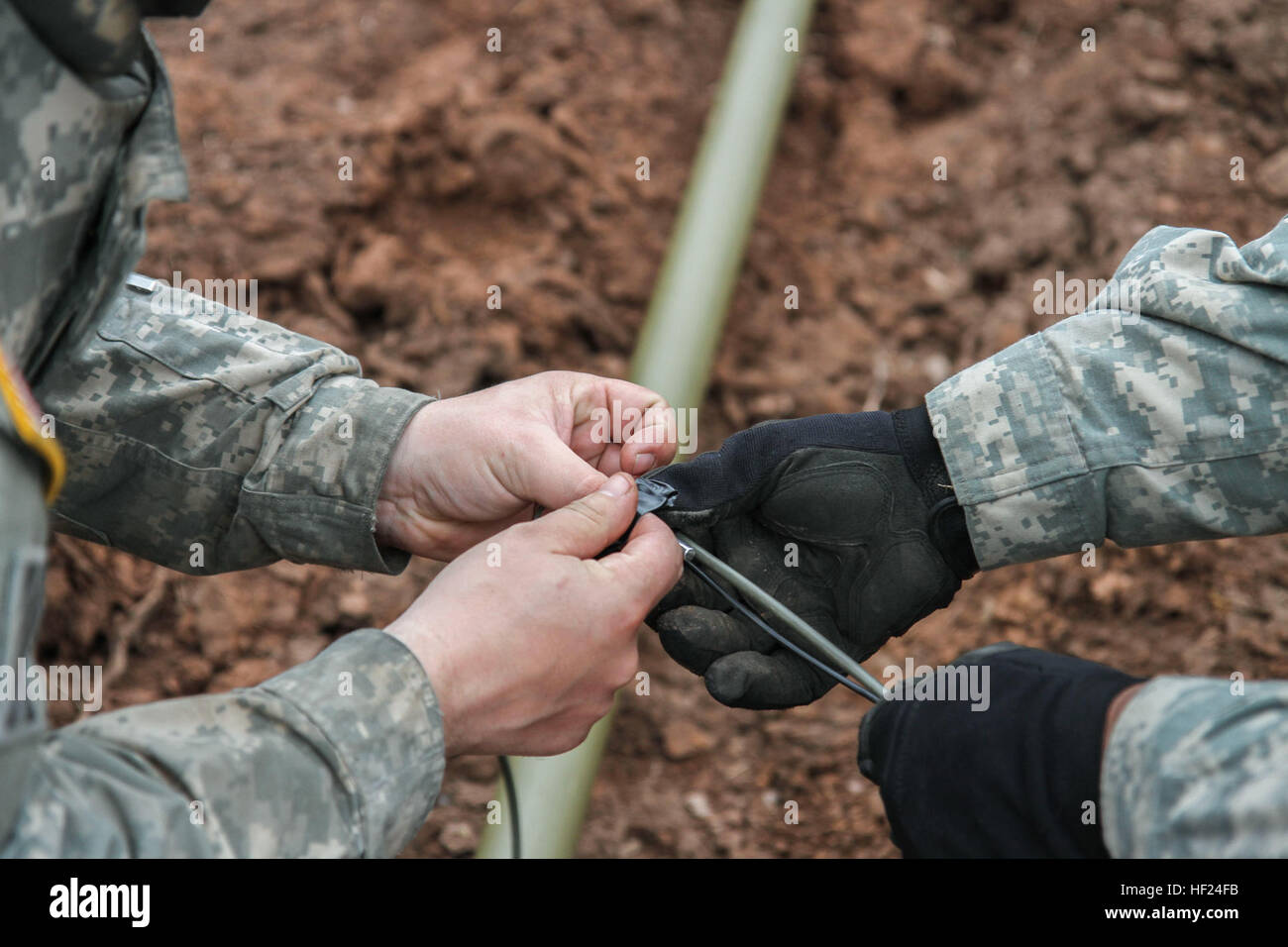 Two Soldiers of the 228th Engineering Company attached wires to connect