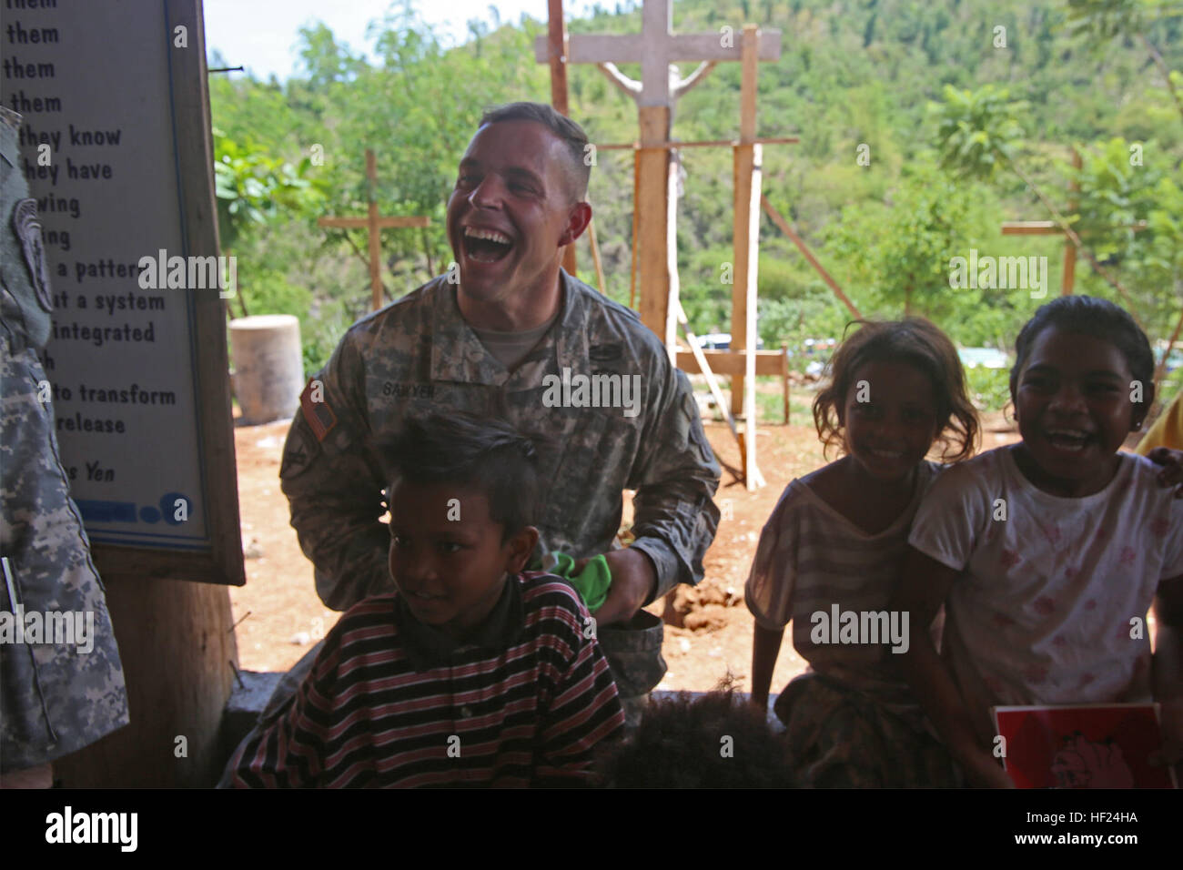 U.S. Army 1st Lt. Dane Sawyer, civil affairs officer with 351st Civil Affairs Command, 405th Civil Affairs Battalion, talks to children of the Aeta tribe during 'Bayanihan' as part of exercise Balikatan 2014, near Fort Ramon Magsaysay, Palayan City, Philippines, May 8. Bayanihan, meaning 'communal spirit' in Filipino, is comprised of food and festivities provided by the Nueva Ecija Cardinals Lion's Club to the local Aeta families with the support of Philippine and U.S. Army soldiers. The exercise is an annual bilateral training exercise between the Philippines and U.S. designed to foster coope Stock Photo