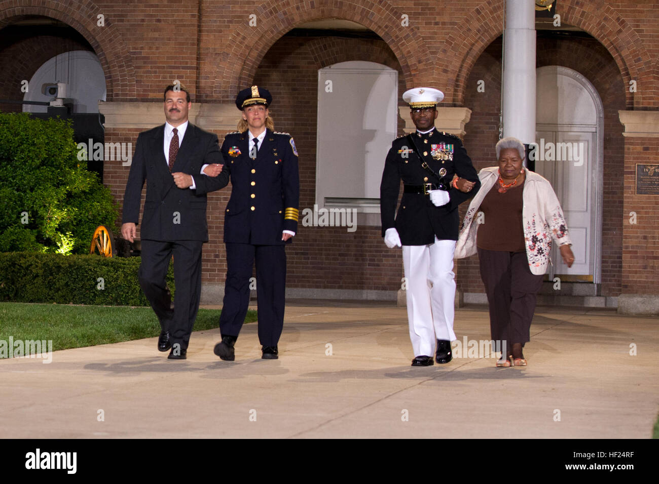 From left, U.S. Park Police Capt. Charles Guddemi; the Evening Parade guest of honor, Metropolitan Police Department Chief Cathy L. Lanier; the parade host, U.S. Marine Lt. Gen. Ronald L. Bailey, deputy commandant of Plans, Policies, and Operations; and Martha Bailey, walk down center walk during an Evening Parade at Marine Barracks Washington in Washington, D.C., May 9, 2014. The Evening Parades are held every Friday night during the summer months. (U.S. Marine Corps photo by Lance Cpl. Samantha Draughon/Released) Evening Parade 140509-M-EL431-321 Stock Photo