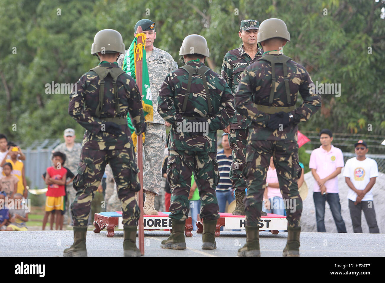 Philippine Army Col. Ronald Villanueva, top-right, chief-of-staff of 7th Infantry Division, and U.S. Army Col. Robert McDowell, top-left, commanding officer of Joint Special Operations Task Force - Philippines, address the color guard at a wreath-laying ceremony May 10 at the Pangatian War Memorial in Cabanatuan, Nueva Ecija, Philippines, during exercise Balikatan 2014. The ceremony honored Philippine and U.S. soldiers interred at the Cabanatuan Prison Camp, some of whom were liberated by Philippine guerrillas and the U.S. Army's 6th Ranger Battalion during a raid Jan. 30, 1945. Balikatan is a Stock Photo