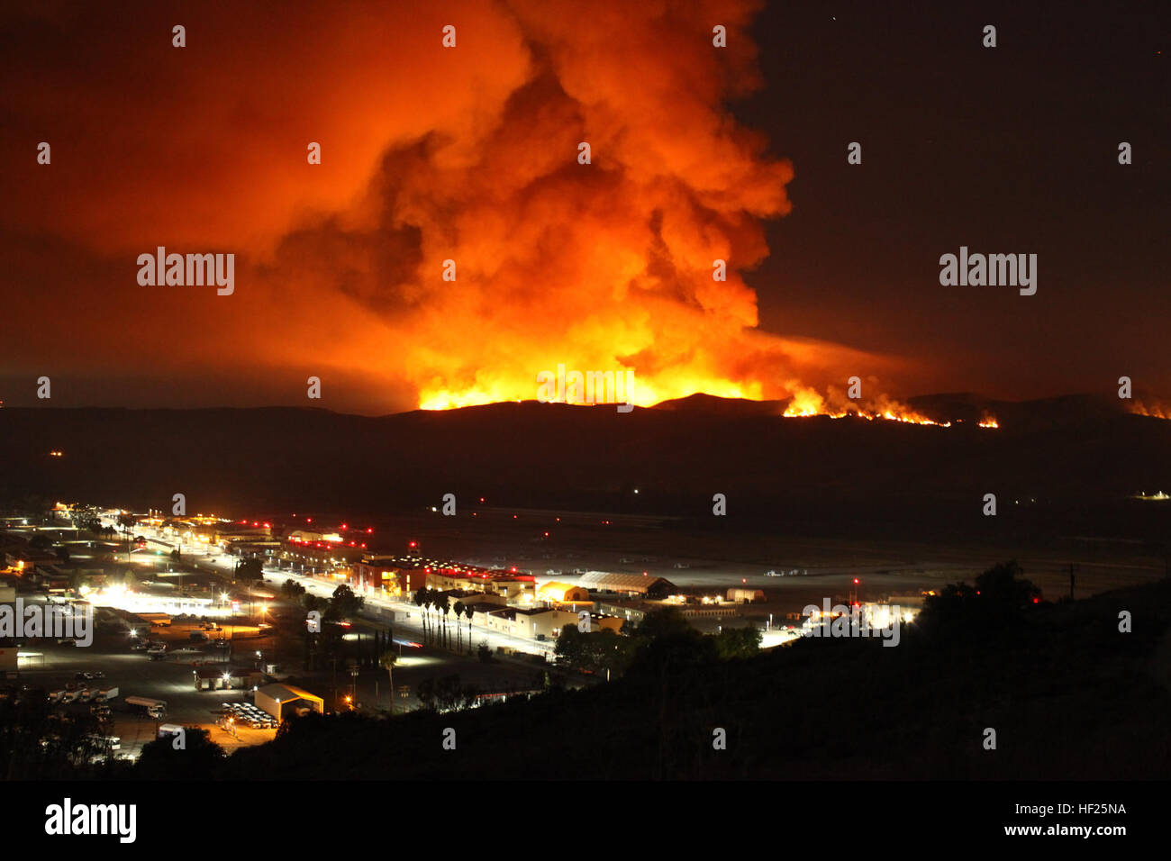 The Las Pulgas Fire burns behind the Marine Corps Air Station at Camp Pendleton, Calif., 16 May, 2014. The Las Pulgas Wildfire on Camp Pendleton has burned more than 15,000 acres and is the largest fire in San Diego County history. (U.S. Marine Corps photo by Sgt. Ethan Johnson/MCIW-MCB CamPen COMCAM/Released) Camp Pendleton Fires 140516-M-HU778-157 Stock Photo