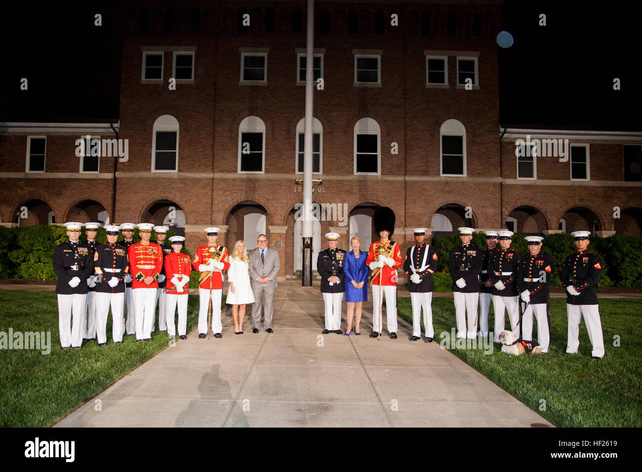 The Evening Parade host, Deputy Commandant for Programs and Resources Lt. Gen. Glenn M. Walters, center right, and the Evening Parade guest of honor, Bob Parsons, center left, pose for a photo with their wives and Marines following the parade at Marine Barracks Washington in Washington, D.C., May 16, 2014. The Evening Parades are held every Friday night during the summer months. (U.S. Marine Corps photo by Cpl. Michael C. Guinto/Released) Evening Parade 140516-M-LI307-678 Stock Photo
