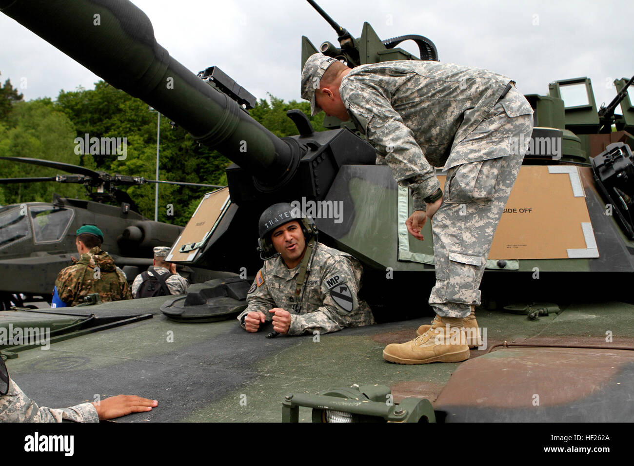 Lt. Col Carter Price, right, commander of 2nd Battalion, 5th Cavalry Regiment, 1st Brigade Combat Team, 1st Cavalry Division coaches Sgt. 1st Class Ivan Alvira, the 1st BCT Provost Marshall noncommissioned officer in charge on how to properly enter the driver's hole of an Abrams tank at Hohenfels Army base during a capabilities day presentation prior to the start of Combined Resolve II. Secretary of the Army John M. McHugh focused on the implementation of U.S. Army Europe's regionally aligned forces concept while observing Soldiers and NATO and European partners at exercise Combined Resolve II Stock Photo