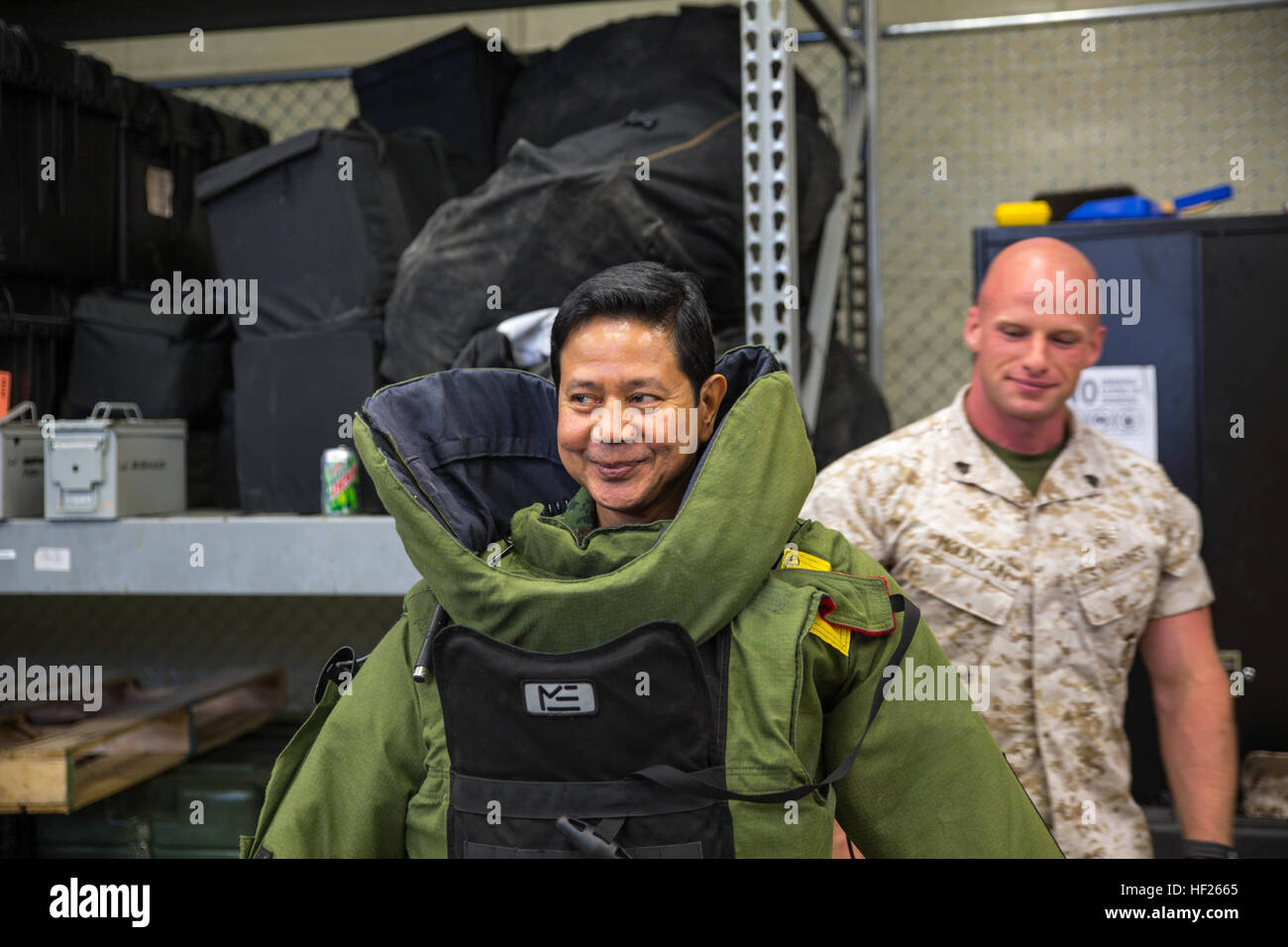 Royal Thai Armed Forces Lt. Gen. Krisda Norapoompipat wears an advanced bomb suit after receiving assistance from U.S. Marine Sgt. Garrett S. Mountain May 19 at Camp Hansen. Norapoompipat visited Camp Hansen to discuss explosive ordnance disposal tactics, techniques and procedures employed by the U.S. Marine Corps, as well as both countries' capabilities for unexploded ordnance disposal training. The Kingdom of Thailand shares a long-standing alliance with the U.S., and both countries frequently work together in humanitarian aid efforts, preparation and training exercises. Norapoompipat is the Stock Photo