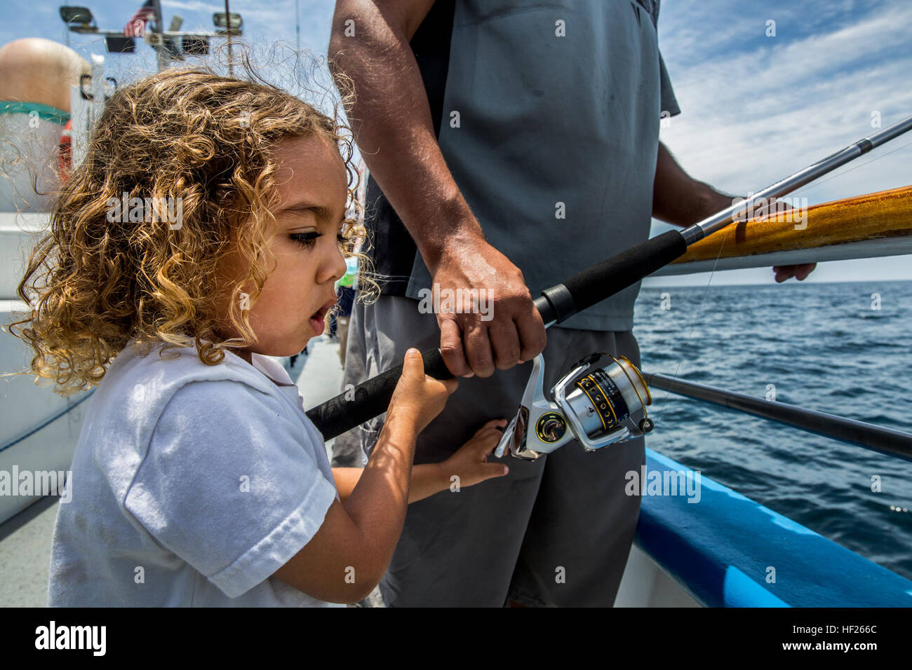 Major, 4, reels in a catch during a youth fishing trip aboard the fishing  vessel Dana Pride June 26, 2014. More than 30 service members and children  participated in the event. (U.S.
