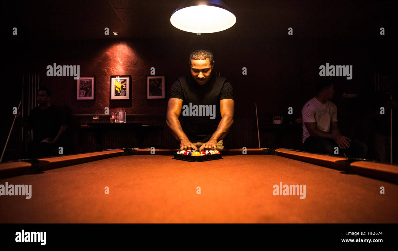 Sergeant Benjamin Eric-King Smith racks the billiard balls before playing a round in Oceanside, Calif., July 22, 2014. Smith, 24, is from Wilmington, Delaware and is currently the transportation coordinator for the 15th Marine Expeditionary Unit aboard Camp Pendleton, Calif.   (U.S. Marine Corps photo by Cpl. Emmanuel Ramos/Released) Warrior Wednesday, Marine from Wilmington, Delaware 140722-M-ST621-001 Stock Photo