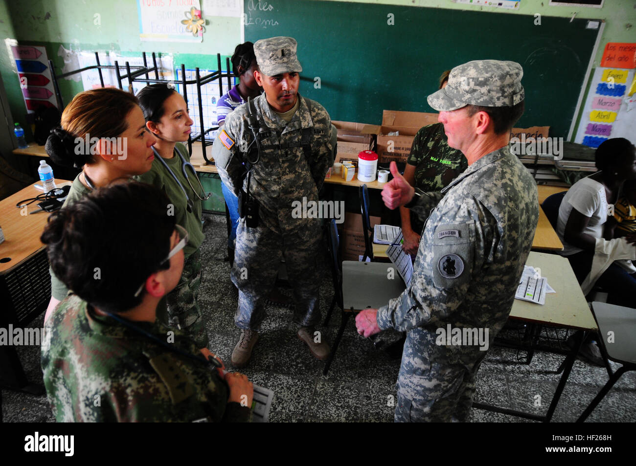 The commanding general of the US Army South, Maj. Gen. Joseph P. DiSalvo, chats with the medical staff comprised of members from various armed forces such as Colombia, Brazil and Canada at the Batey Cinco medical site during his visit to the Task Force Larimar troops working across different locations in Barahona, Dominican Republic on May 20. TF Larimar, the force behind Beyond the Horizon 2014 Training Exercise, is currently conducting engineering work at five different sites. Three of the sites will be medical clinics and the other two will be used as school partitions in the province of Ba Stock Photo
