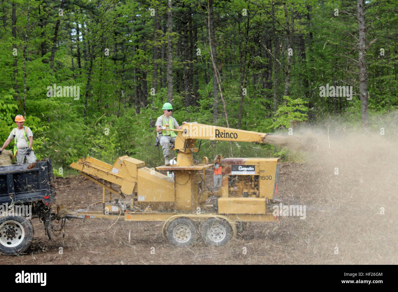 Tech. Sgt. Virgil Harris prepares to load a bale of hay into a hay