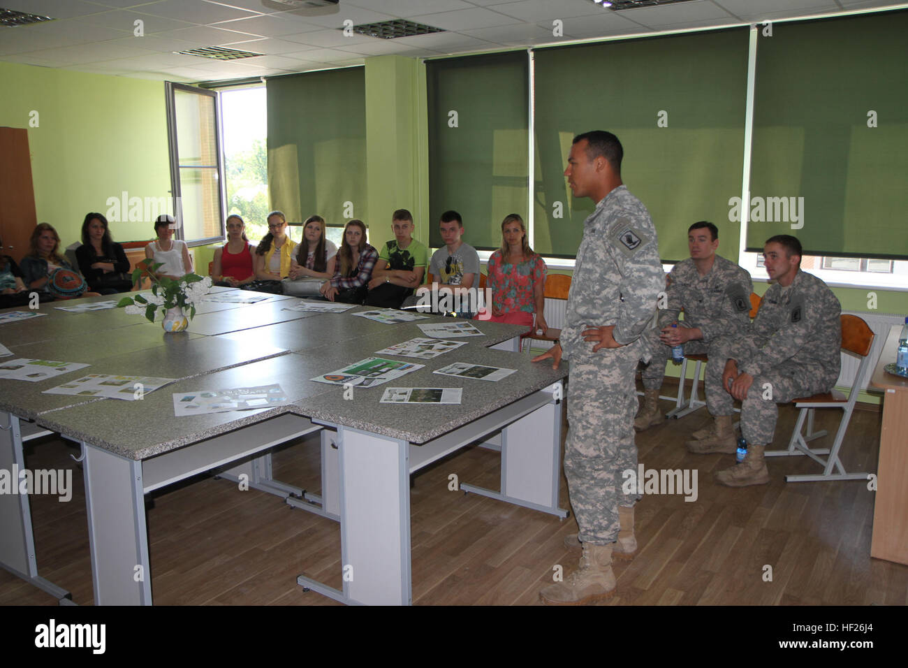 U.S. Army 1st Lt. Ryan Johnson, a platoon leader assigned to 1st Battalion, 503rd Infantry Regiment, 173rd Airborne Brigade, introduces himself to students at Adazu Secondary School in Adazi, Latvia, May 26, 2014. The paratroopers from the 173rd Airborne visited the school as part of a cultural visit. They answered questions and played games with the students, while also learning about Latvian geography, culture and language. (U.S. Army photo by Capt. Corissa Barton, Michigan National Guard) US paratroopers spend Memorial Day speaking with Latvian children 140526-Z-CB999-002 Stock Photo