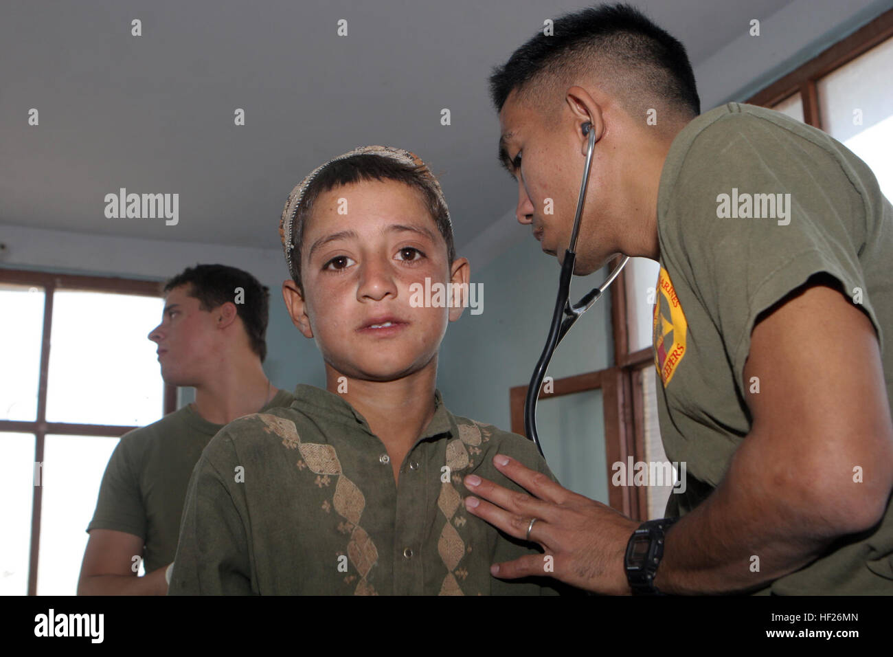 080824-M-8000M-013 DELERAM, Afghanistan (Aug. 24, 2008) Hospital Corpsman 1st Class Louie Bismonte, assigned to 2nd Battalion 7th Marines, treats a local child in the city of Deleram. Based at Marine Air Ground Combat Center Twenty Nine Palms, 2nd Battalion 7th Marines, is a reinforced light infantry battalion deployed to Afghanistan supporting Operation Enduring Freedom. (U.S. Marine Corps photo by Lance Cpl. James T. McKenzie/Released) US Navy 080824-M-8000M-013 Hospital Corpsman 1st Class Louie Bismonte, assigned to 2nd Battalion 7th Marines, treats a local child in the city of Deleram Stock Photo