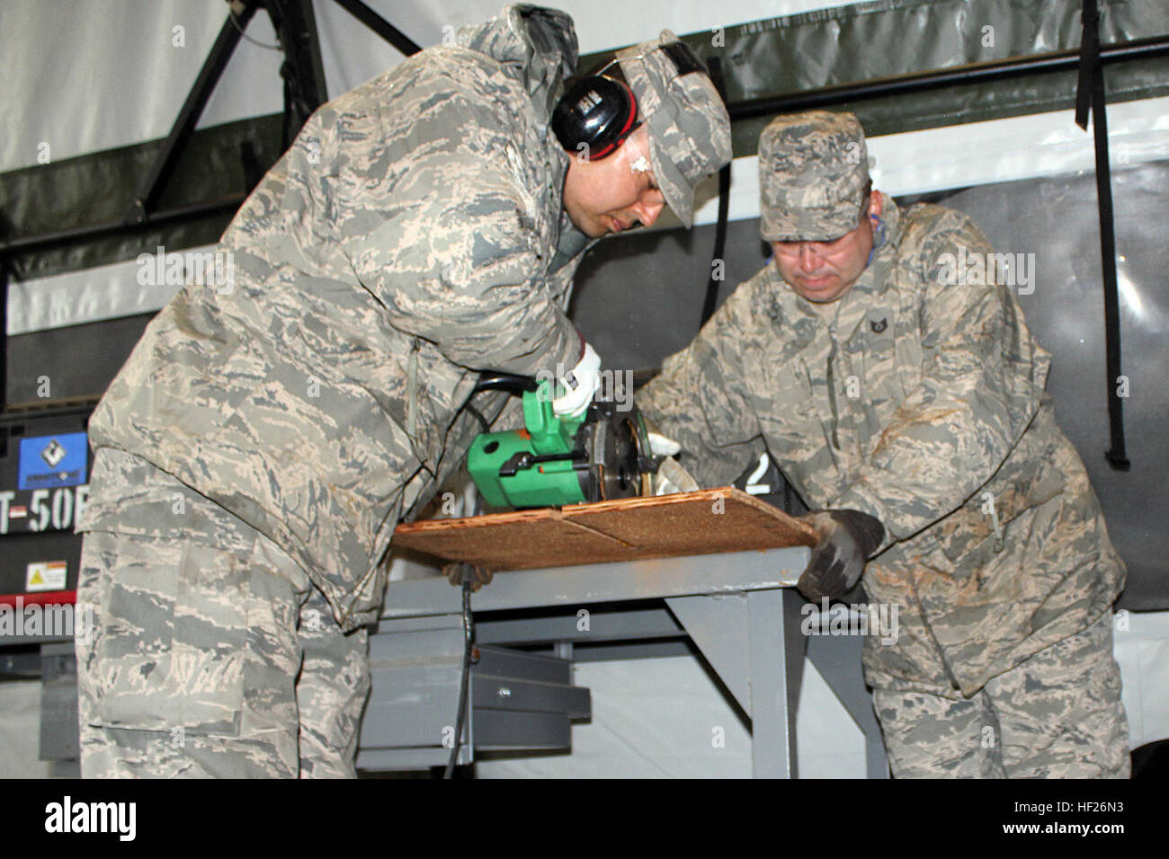 Staff Sgt. Richard Sanchez and Tech. Sgt. Jeff Motto cut some lumber to