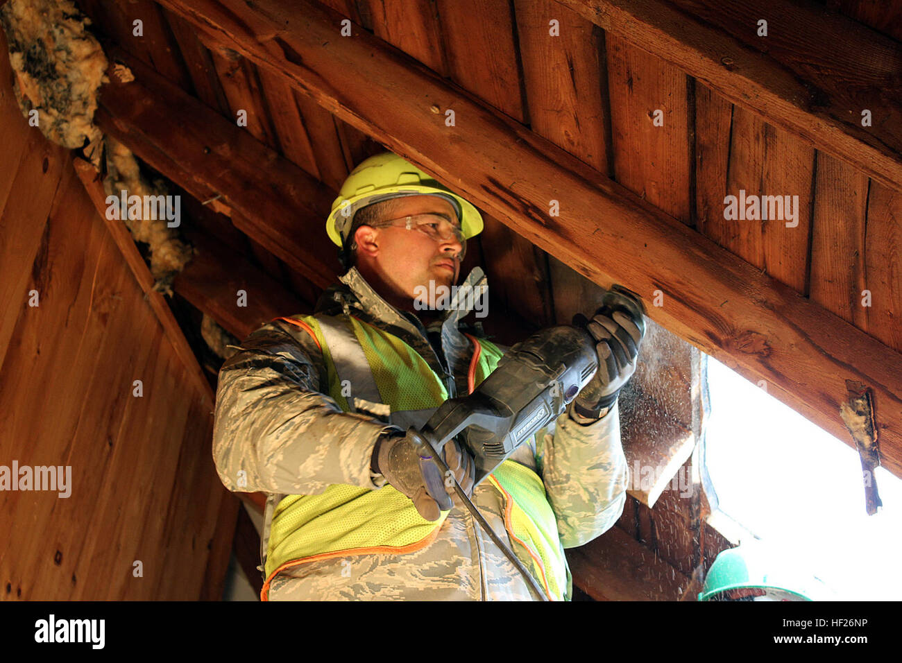Staff Sgt. Richard Sanchez cuts out a piece of the roof of a building
