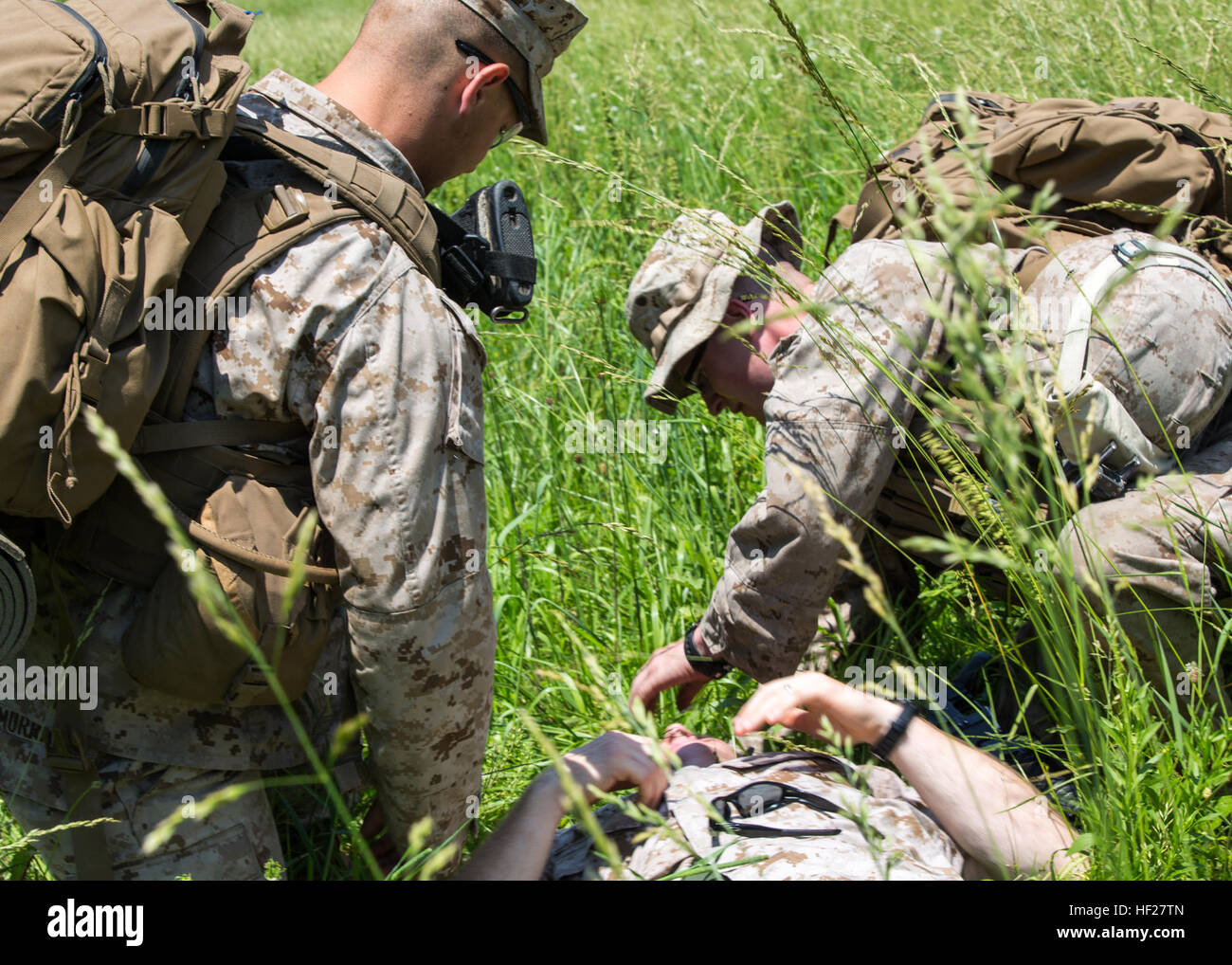 Marines with Fox Company, 2nd Battalion, 2nd Marine Regiment (2/2), conduct field medical treatment on a simulated casualty during embassy reinforcment training aboard Quantico, Va., June 11. The 26th Marine Expeditionary Unit, 2/2 and VMM-264 conducted embassy reinforcement training June 10 to 13, 2014. Marines conducted the training to prepare for possible real world scenarios. (U.S. Marine Corps photo by Lance Cpl. Joshua W. Brown/Released) Mission Readiness Exercise 140611-M-AW179-034 Stock Photo