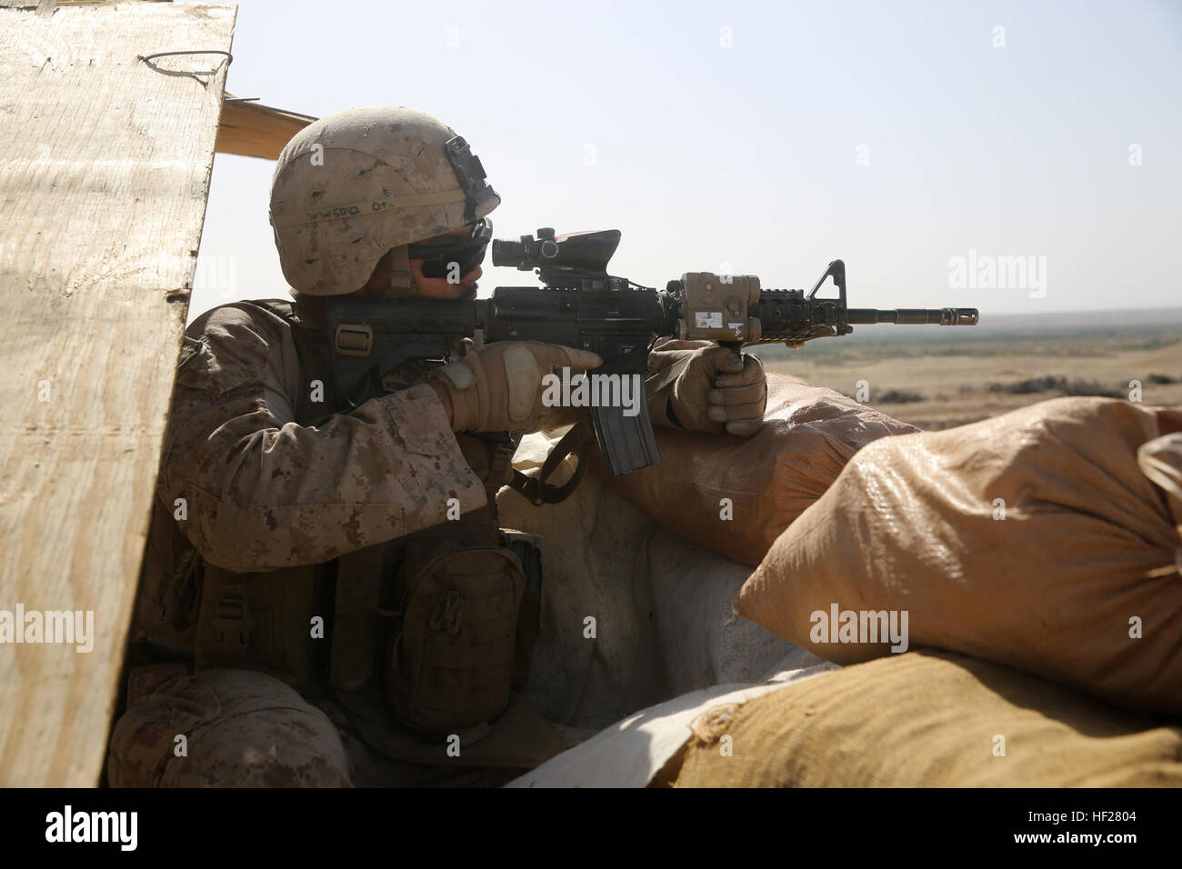 Lance Cpl. Jeffery Webb, anti-tank missileman, Weapons Company, 1st Battalion, 7th Marine Regiment, mans a security post during a mission in Helmand province, Afghanistan, June 13, 2014. Webb, a native of Montgomery, Texas, along with a platoon of infantrymen, provided security at Patrol Base Ouellette, an Afghan National Army controlled-base, during the Afghanistan presidential runoff elections. While International Security Assistance Force stood ready to support as needed, the elections were entirely Afghan led and Afghan conducted. Infantrymen stand by ready to assist during Afghan election Stock Photo