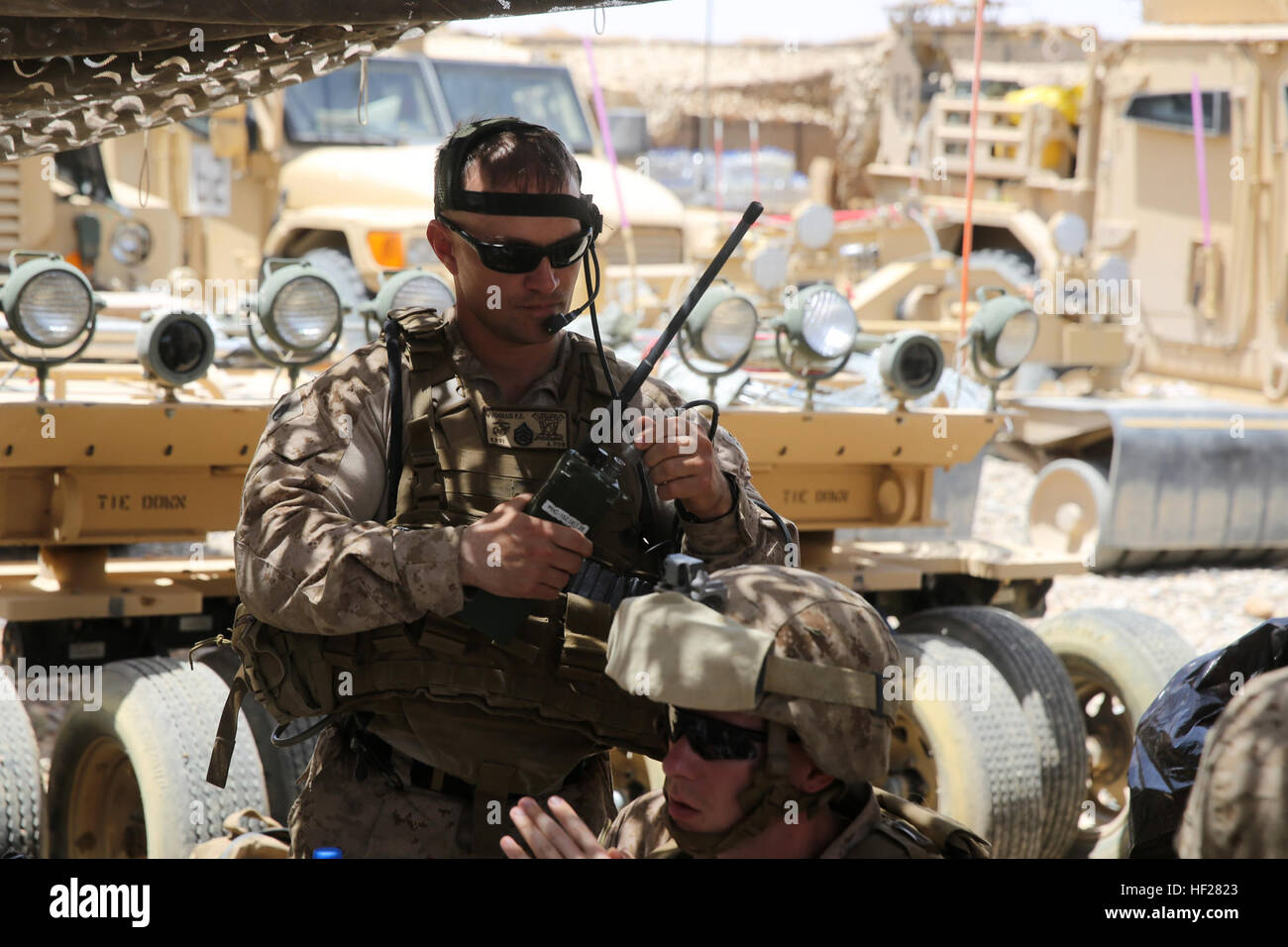 Staff Sgt. Paul Prograis, joint terminal attack controller, Headquarters and Service Company, 1st Battalion, 7th Marine Regiment, establishes radio connectivity during a mission in Helmand province, Afghanistan, June 13, 2014. Prograis, a native of Girard, Ill., along with a platoon of infantrymen, provided security at Patrol Base Ouellette, an Afghan National Army controlled-base, during the Afghanistan presidential runoff elections. While International Security Assistance Force stood ready to support as needed, the elections were entirely Afghan led and Afghan conducted. Infantrymen stand by Stock Photo