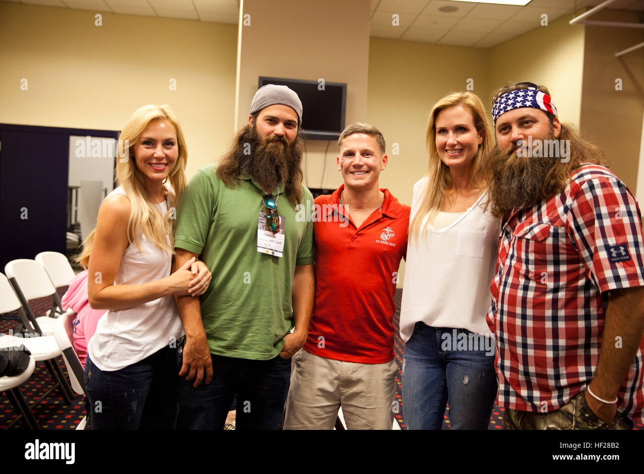 Retired U.S. Marine Corps Cpl. William Kyle Carpenter, center, poses for a photo with reality television stars Willie Robertson, right, and Jason Robertson, second from left, after attending a baseball game at Nationals Park in Washington, D.C., June 17, 2014. Carpenter will receive the Medal of Honor from the President of the United States Barack Obama during a ceremony at the White House on Thursday, June 19, 2014. (U.S. Marine Corps photo by Cpl. Michael C. Guinto/Released) Medal of Honor Kyle Carpenter 140617-M-LI307-452 Stock Photo