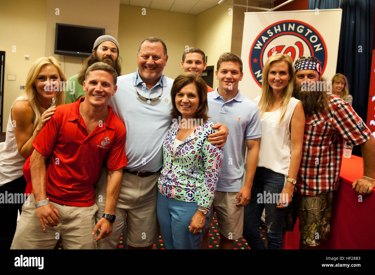 Retired U.S. Marine Corps Cpl. William Kyle Carpenter, second from left, poses for a photo with family members and reality television stars after attending a baseball game at Nationals Park in Washington, D.C., June 17, 2014. Carpenter will receive the Medal of Honor from the President of the United States Barack Obama during a ceremony at the White House on Thursday, June 19, 2014. (U.S. Marine Corps photo by Cpl. Michael C. Guinto/Released) Medal of Honor Kyle Carpenter 140617-M-LI307-484 Stock Photo