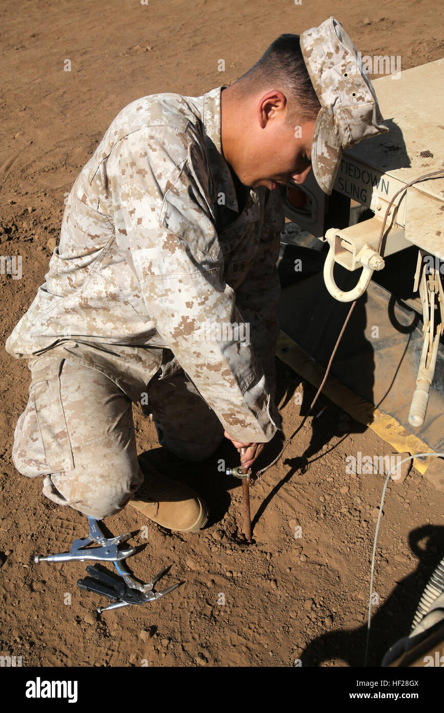 Corporal Allan Lopatinsky, a water support technician with I Marine Expeditionary Force Headquarters Group, adjusts a light during the 2014 I Marine Expeditionary Brigade command post exercise aboard Camp Pendleton, Calif., June 19, 2014. The CPX was designed to help improve the 1st Marine Expeditionary Brigade's readiness for deployment. (U.S. Marine Corps photo by Lance Cpl. David Silvano/released) BHG ensures mission accomplishment for CPX3 140619-M-vz999-004 Stock Photo