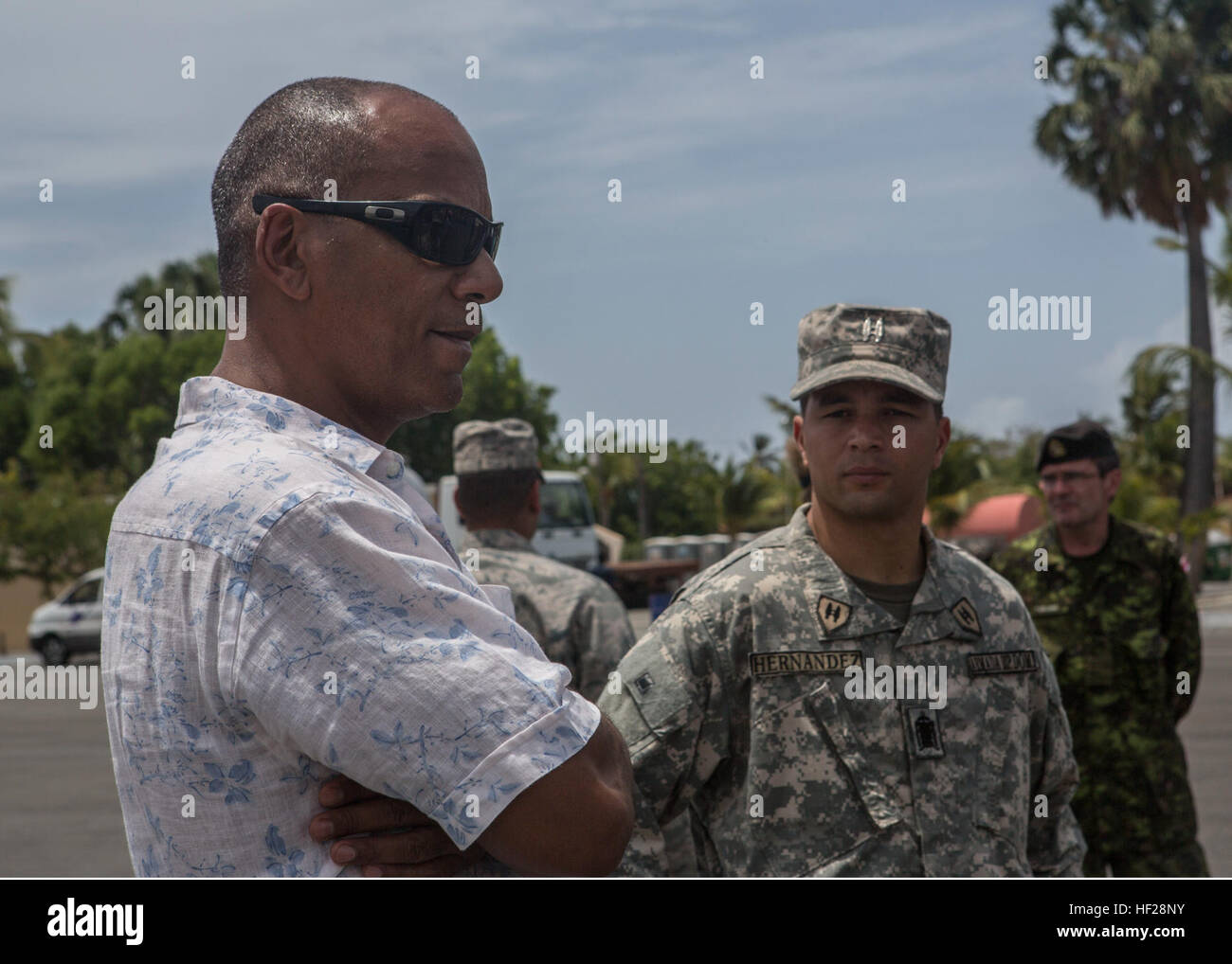 Moses Alou, former major league baseball player,  speaks with officers from the U.S. Marines with Charley Company, 4th Law Enforcement Battalion, Marine Forces Reserve, and from the 13 partner nations that are stationed aboard the Dominican Naval Base, Las Calderas located near Bani, Dominican Republic during Exercise Tradewinds 2014, June 21, 2014. Ambassador Brewster visited the naval base and had the opportunity to observe some of the training evolutions taking place as part of phase II of the exercise. Phase II of Tradewinds 2014 is mostly a ground field training exercise held from June 16 Stock Photo