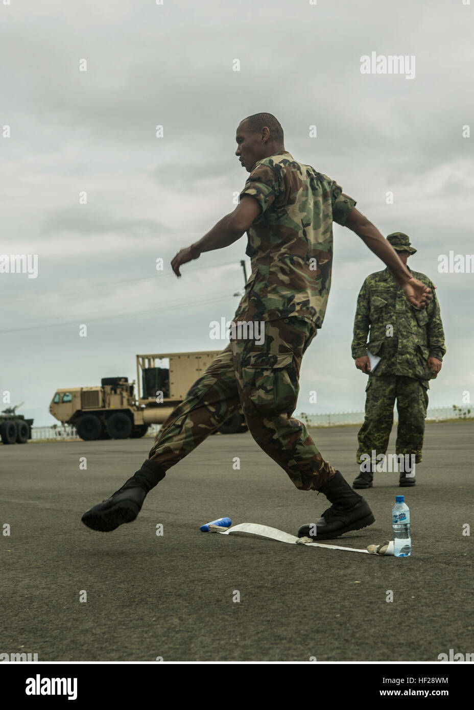 Sgt. Augustin Christmas, Antigua and Barbuda, member of Team one, kicks a soccer ball as part of the soccer penalty kicks portion of the squad competition to mark the final training day of the joint and combined exercise. Twelve teams comprised by one member of each partner nation competed for bragging rights in events like interior urban tactics training, interior close quarter battles and room clearings portion of the combined group competitions during Tradewinds 2014 aboard Dominican Naval Base, Las Calderas, located near Bani, Dominican Republic, June 24, 2014. U.S. Marines with Charley Co Stock Photo