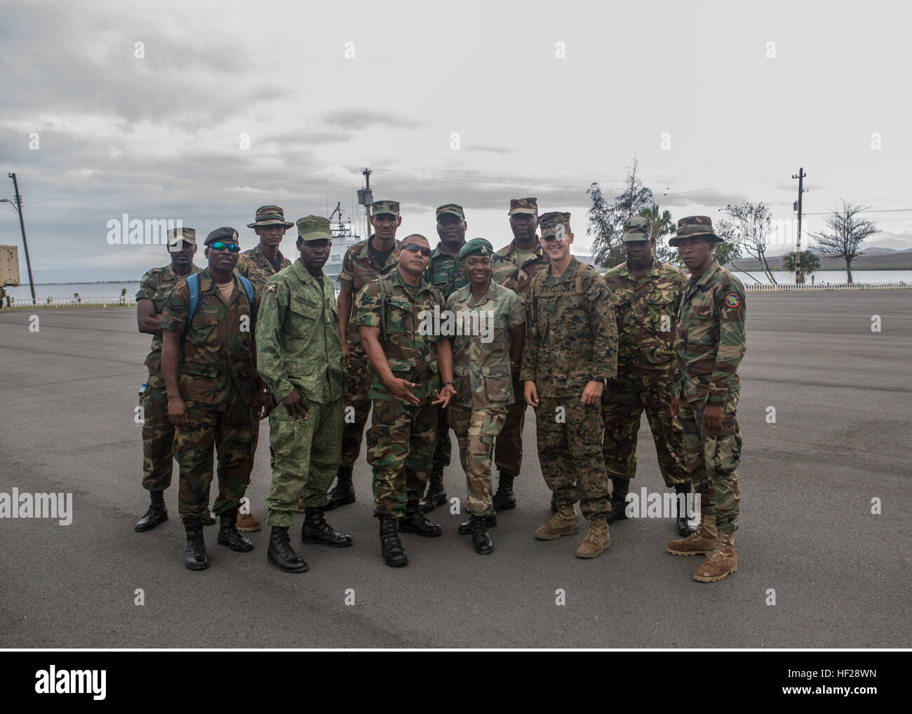 Members of Team one pose for a photograph at the end of the squad competition to mark the final training day of the joint and combined exercise. Twelve teams comprised by one member of each partner nation competed for bragging rights in events like interior urban tactics training, interior close quarter battles and room clearings portion of the combined group competitions during Tradewinds 2014 aboard Dominican Naval Base, Las Calderas, located near Bani, Dominican Republic, June 24, 2014. U.S. Marines with Charley Company, 4th Law Enforcement Battalion, Marine Forces Reserve, and soldiers wit Stock Photo