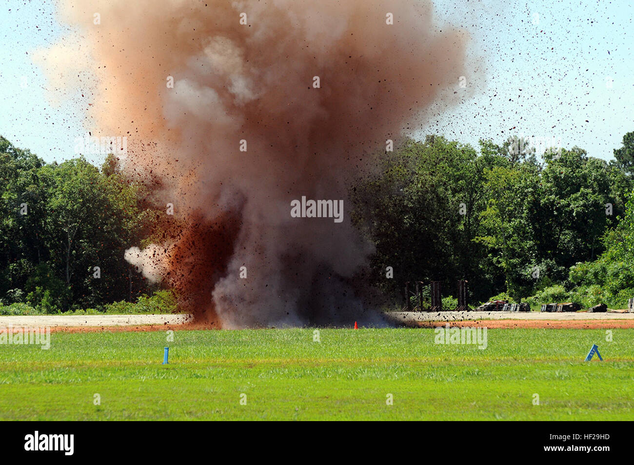 Debris fly higher than the tops of trees during an explosives