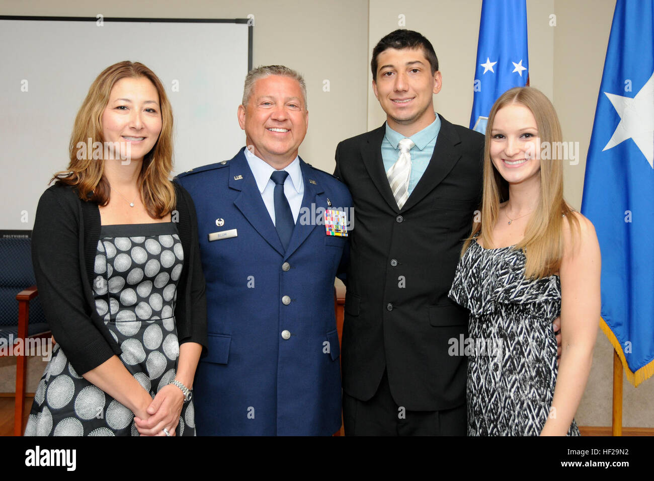 Col. Scott Blum, 108th Medical Group commander, poses for a photograph with family and friends after his promotion ceremony at Joint Base McGuire-Dix-Lakehurst, N.J., July 7, 2014. (U.S. Air National Guard photo by Senior Airman Kellyann Novak/Released) (This image was cropped to focus on the subject of the image) Col. Scott Blum's promotion ceremony 140707-Z-ME883-032 Stock Photo