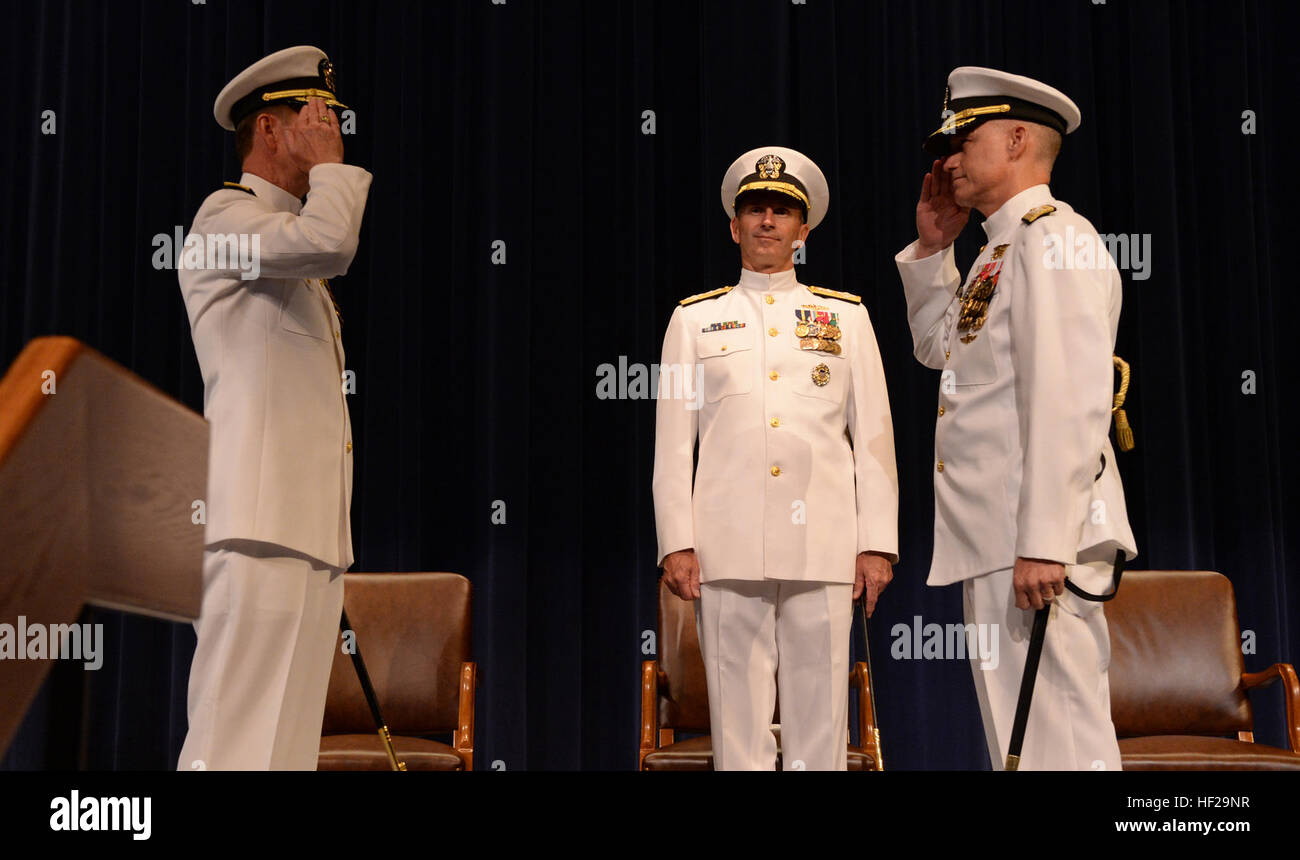 Rear Adm. Walter E. 'Ted' Carter Jr., is relieved by Rear Adm. P. Gardner Howe III as president, U.S. Naval War College (NWC) in Newport, R.I., during a change of command ceremony with Chief of Naval Operations Adm. Jonathan Greenert (center). During the ceremony, Howe relieved Carter and became the 55th president and first Navy SEAL in command of the NWC. Howe, a U.S. Naval Academy, Naval Postgraduate School and National War College graduate, holds dual Master of Arts degrees in national security and reports from his most recent assignment as commander of Special Operations Command, Pacific.  Stock Photo