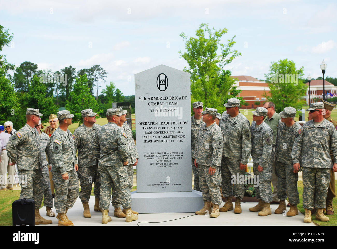 Soldiers from the 30th Armored Brigade Combat Team (successor to 30th Infantry Division) look at the monument that honors their ancestors and their own current success at the National Infantry Museum Walk of Honor at Fort Benning, June 2, 2013. Soldiers from World War II and the modern day 30th ABCT took part in the ceremony that honored the unit for their service from past to present. The 30th ID was known as the 'Workhorse of the Western Front,' and was most noted for breaching the famed Siegfried Line, which led to the capture of the first German city of Aachen in 1944. The 30th ABCT deploy Stock Photo
