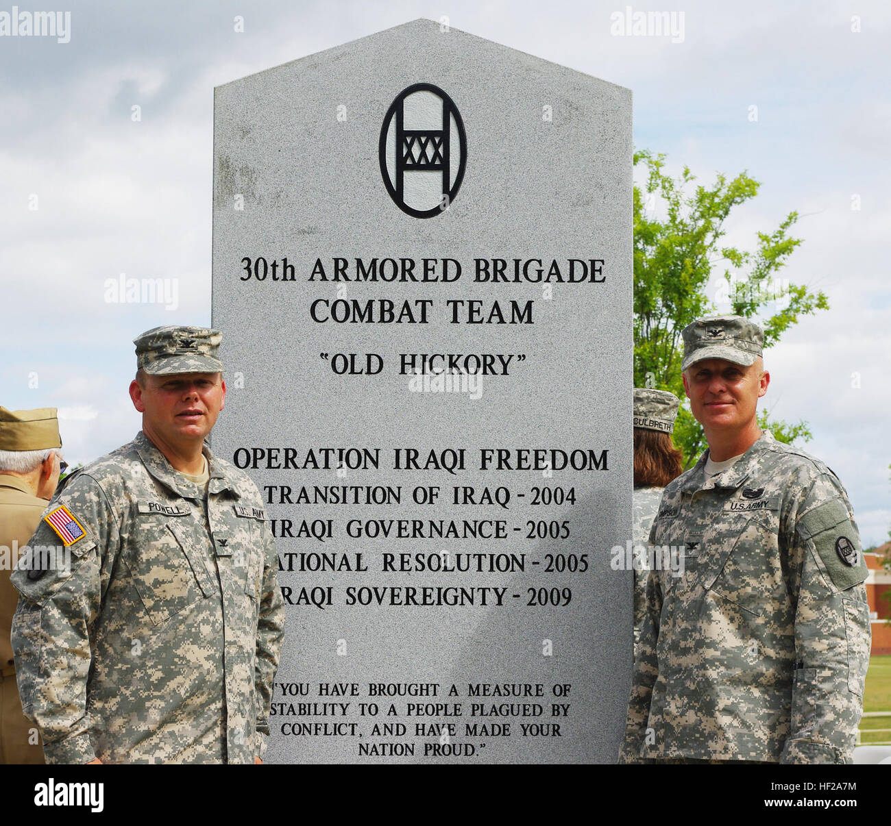 (From left to right) Commander Col. Randy Powell and Deputy Commander Col. Sonny Simpson, 30th Armored Brigade Combat Team leaders, have their picture taken at the new 30th Infantry Division and 30th ABCT monument at the National Infantry Museum Walk of Honor at Fort Benning, June 2, 2013. The two leaders were part of a host of soldiers from World War II and the modern day 30th ABCT took part in the ceremony that honored the unit for their service from past to present. The 30th ABCT deployed twice in support of Operation Iraqi Freedom, serving in 2004 in the Diyala Province and again in 2009 n Stock Photo