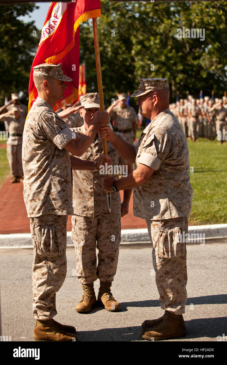 U.S. Marine Corps Maj. Gen. William D. Beydler, left, incoming commanding general, II Marine Expeditionary Force (MEF), receives the unit's battle colors from Maj. Gen. Raymond C. Fox, right, outgoing commanding general, II MEF, during a change of command ceremony for II MEF on Camp Lejeune, N.C., July 17, 2014. The passing of the colors represents Fox relinquishing command to Beydler. (U.S. Marine Corps photograph by Lance Cpl. Christopher A. Mendoza, 2nd MARDIV, Combat Camera/Released) II MEF Change of Command Ceremony 140717-M-BZ307-074 Stock Photo