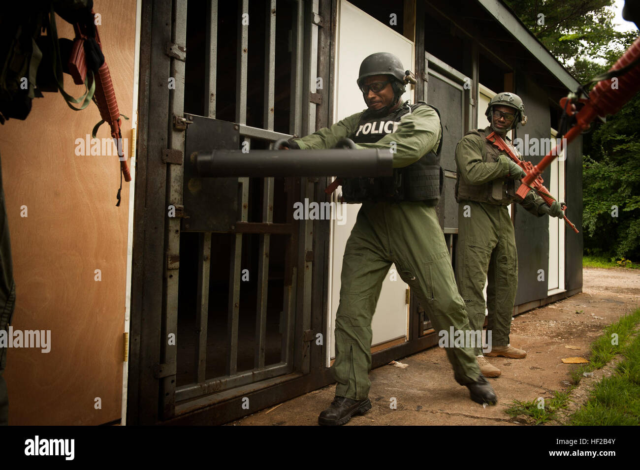 A U S Police Officer Uses A Ram To Breach Through A Door During A