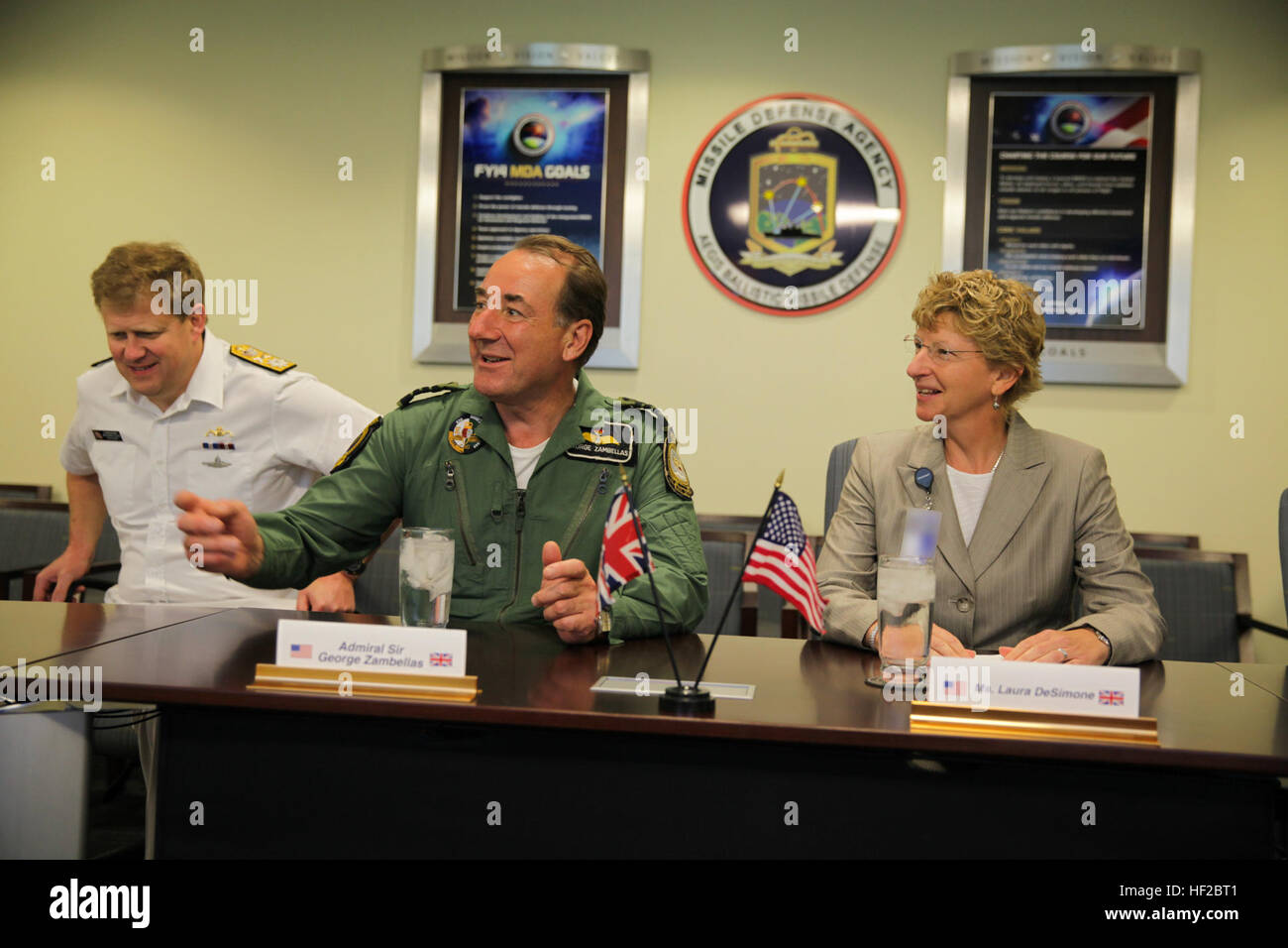 The First Sea Lord and Chief of Naval Staff of the British Royal Navy, Adm. Sir George Zambellas, center, attends a brief alongside Laura DeSimone at the Missile Defense Agency at Dahlgren, Va., July 29, 2014. Zambellas is taking part in the Commandant of the Marine Corps' Counterpart Program, which invites foreign military leaders to visit the United States and interact with U.S. military leaders. (U.S. Marine Corps photo by Cpl. Michael C. Guinto/Released) Note: portions of this image have been blurred for security. First Sea Lord Counterpart Visit 140729-M-LI307-478 Stock Photo