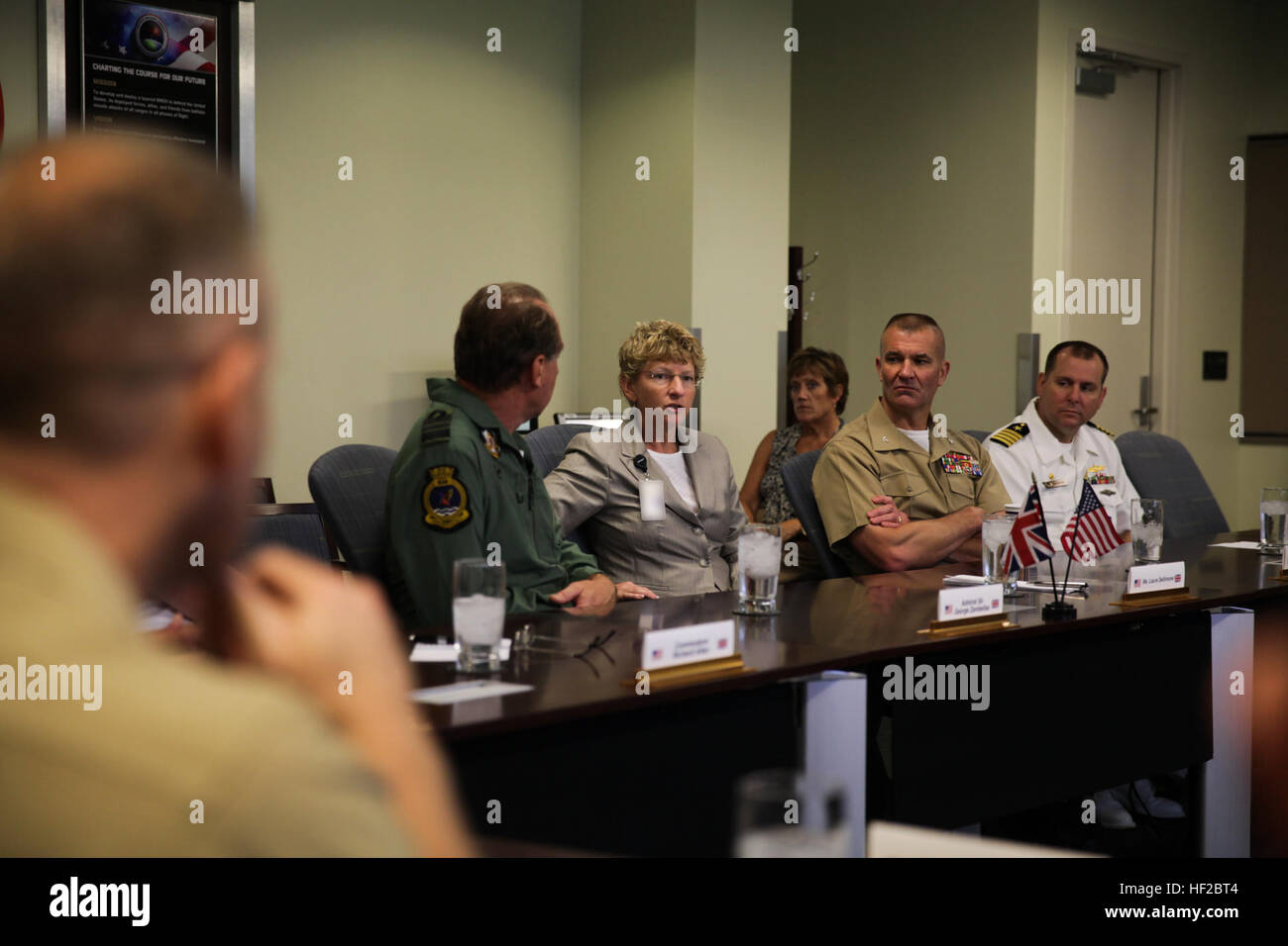 The First Sea Lord and Chief of Naval Staff of the British Royal Navy, Adm. Sir George Zambellas, left, attends a brief alongside Laura DeSimone, center, and U.S. Marine Corps and Navy personnel at the Missile Defense Agency at Dahlgren, Va., July 29, 2014. Zambellas is taking part in the Commandant of the Marine Corps' Counterpart Program, which invites foreign military leaders to visit the United States and interact with U.S. military leaders. (U.S. Marine Corps photo by Cpl. Michael C. Guinto/Released) Note: portions of this image have been blurred for security. First Sea Lord Counterpart V Stock Photo