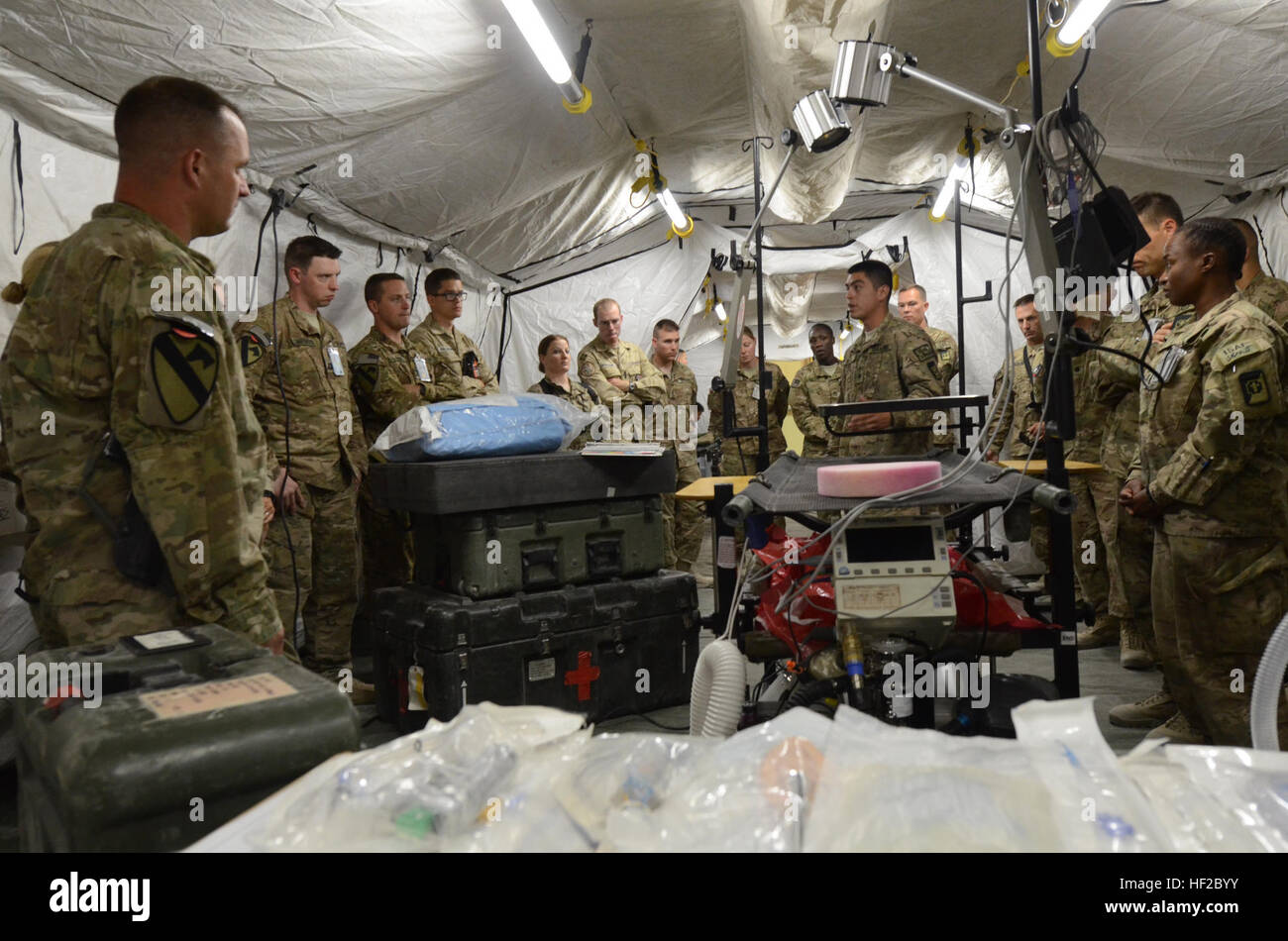 Spc. Daniel Soto, an operating room technician with the 250th Forward Surgical Team from Joint Base Lewis-McChord, Wash., gives a tour of the operating room in the FST's mobile hospital tent to a group of Soldiers from Regional Command-South at Kandahar Airfield, Afghanistan, July 30, 2014. The tour was to give visitors a better idea of the operational capabilities of the FST. (U.S. Army photo by Staff Sgt. John Etheridge) 250th FST sets up portable hospital to demonstrate lifesaving capabilities 140730-Z-BQ261-048 Stock Photo