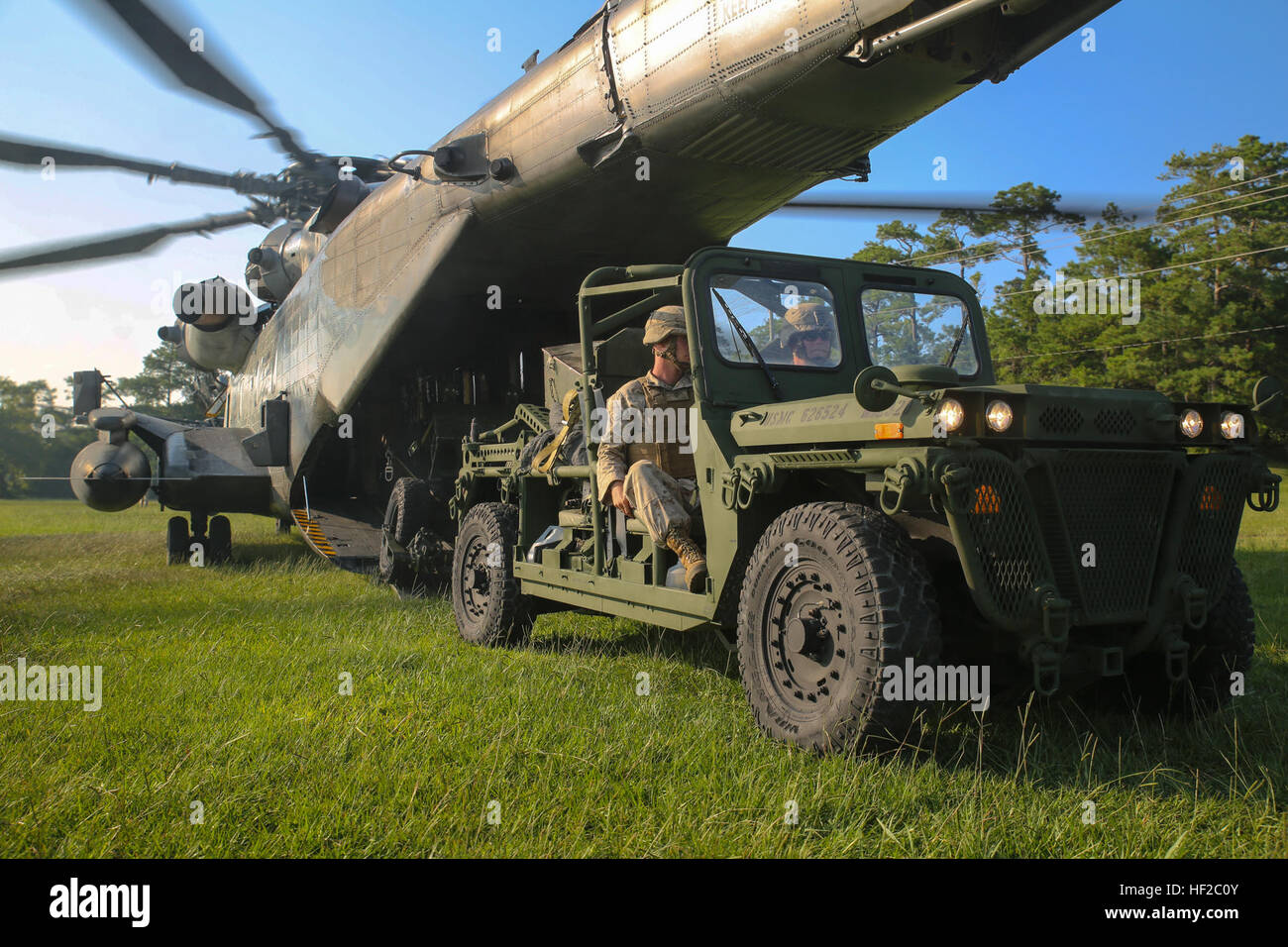 Marines with 2nd Battalion, 10th Marine Regiment, 2nd Marine Division, drive an Expeditionary Fire Support System on board a CH-53E Super Stallion to begin an aerial-assault, training mission aboard Marine Corps Base Camp Lejeune, North Carolina, July 30, 2014. The EFSS consists of an Internally Transportable-Strike Vehicle and the 120mm mortar, which is used to bridge the gap of range between 81 mm mortars and 155 mm cannons.  (U.S. Marine Corps photo taken by Lance Cpl. Alex W. Mitchell/released) EFSS teams conduct amphibious assaults, aerial raid training 140730-M-AM089-0527 Stock Photo