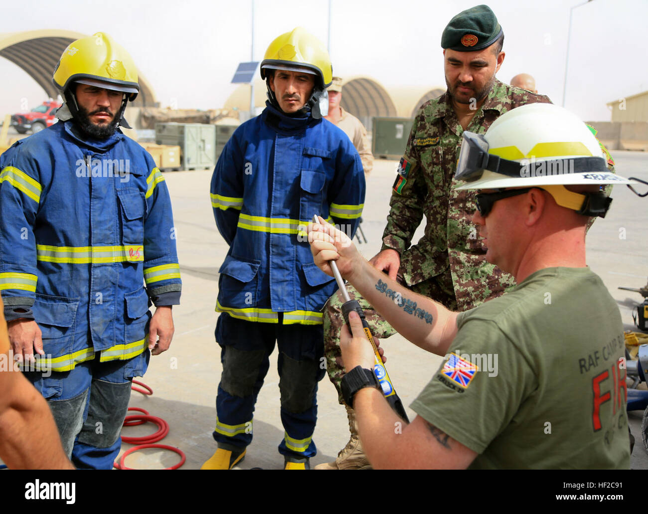 Staff Sgt. Brock H. Sinclair, aircraft rescue and firefighting section leader with Marine Wing Support Squadron (MWSS) 274, instructs Afghan National Army (ANA) soldiers with 215th Corps, Garrison Support Unit, on the correct procedures of inflating and deflating rubber air jacks, part of the F550 fire truck aboard Camp Bastion, Helmand province, Afghanistan, on Aug. 2, 2014. The Marines and ANA conducted the training to increase proficiency as coalition forces redeploy. (Official U. S. Marine Corps photo by Sgt. Dustin D. March/Released) ANA soldiers Conduct Fire Training 140802-M-EN264-293 Stock Photo
