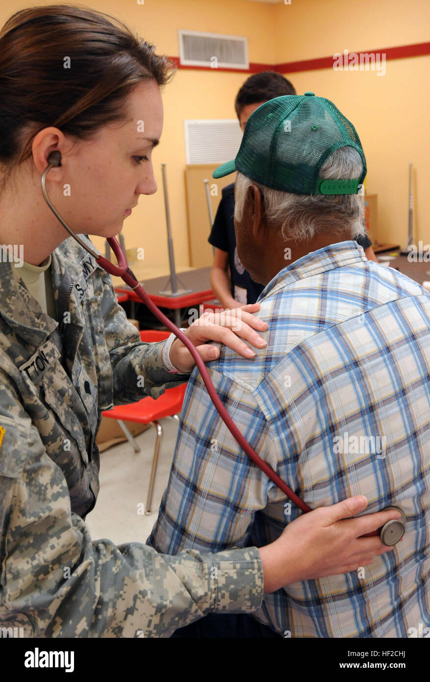 Spc. Amanda Patton, Texas Medical Command, Texas Army National Guard, performs a physical examination on a patient during Operation Lone Star in Rio Grande City, Texas, Aug. 5, 2014. Operation Lone Star is an emergency preparedness exercise conducted by the Texas Department of State Health Services, the Texas Military Forces, local and state organizations and volunteers to help them prepare for natural and man-made disasters. The operation also provides basic physical health assessments, routine vaccinations, vision screenings, and other services to area residents throughout the Rio Grande Val Stock Photo