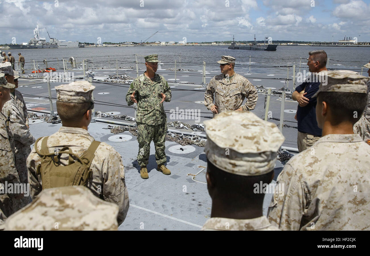 U.S. Navy Lt. Cmdr. David Matvay, a company commander with Amphibious Construction Battalion 2, speaks to Marines with Combat Logistics Regiment 25 during a lighterage craft tour aboard Naval Station Mayport in Jacksonville, Fla., Aug. 5, 2014. During the Maritime Prepositioning Force Exercise 14, Seabees and Marines are working together to complete the month long training exercise in order to increase the units' crisis response capabilities. This exercise, led by the 2nd Marine Expeditionary Brigade and Expeditionary Strike Group Two, is one part of BOLD ALLIGATOR 2014, the year's largest amp Stock Photo