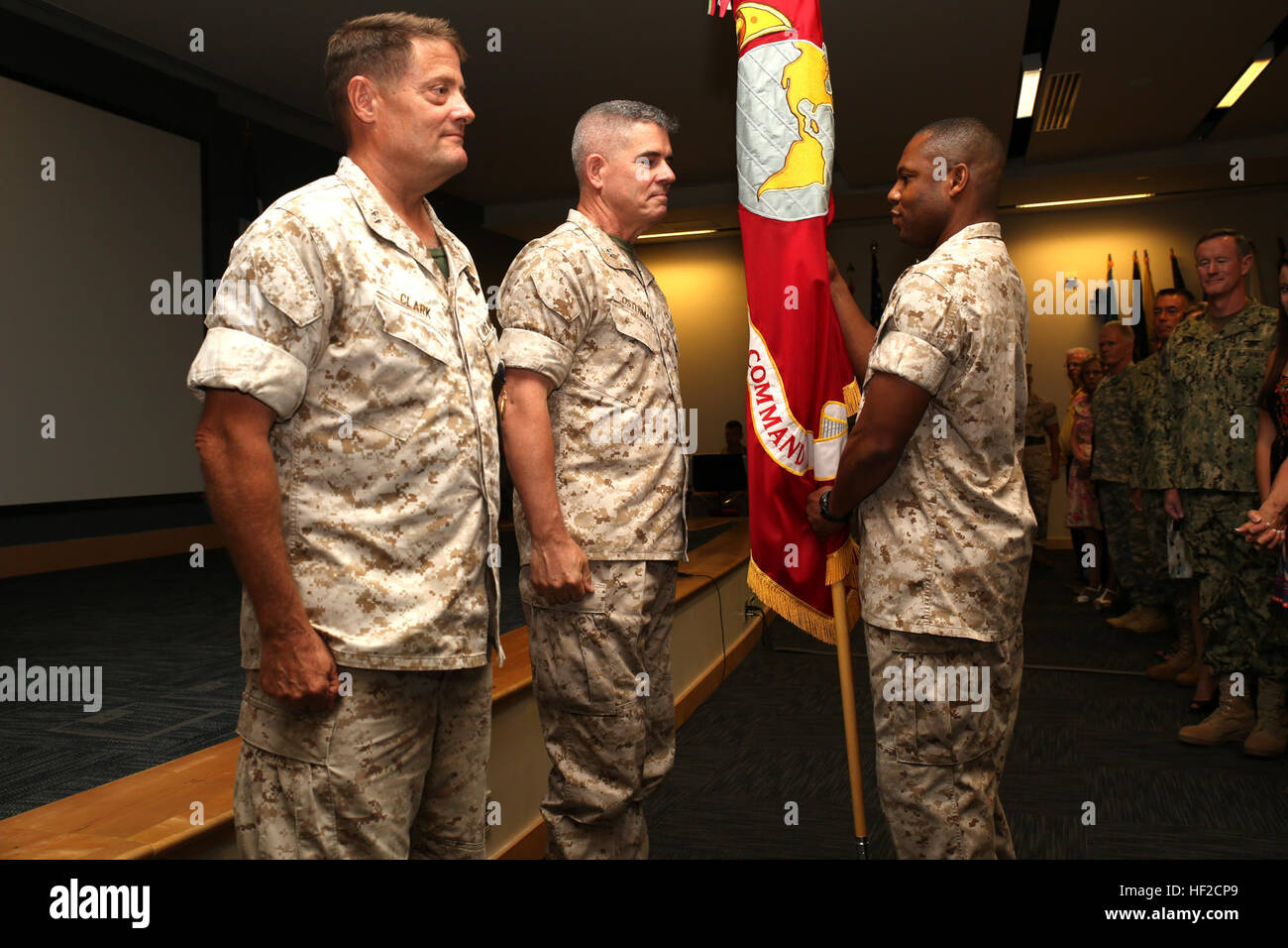 U.S. Marine Corps Sgt. Major John W. Scott passes the Marine Corps colors from Maj. Gen. Mark A. Clark, the outgoing Marine Corps Forces Special Operations Command commander, to Maj. Gen. Joseph L. Osterman, the incoming MARSOC commander, during a change of command ceremony aboard Stone Bay at Camp Lejeune, N.C., Aug. 6, 2014. (U.S. Marine Corps photo by Cpl. Donovan J. Lee/Released) MARSOC welcomes new commander 140806-M-LS286-003 Stock Photo