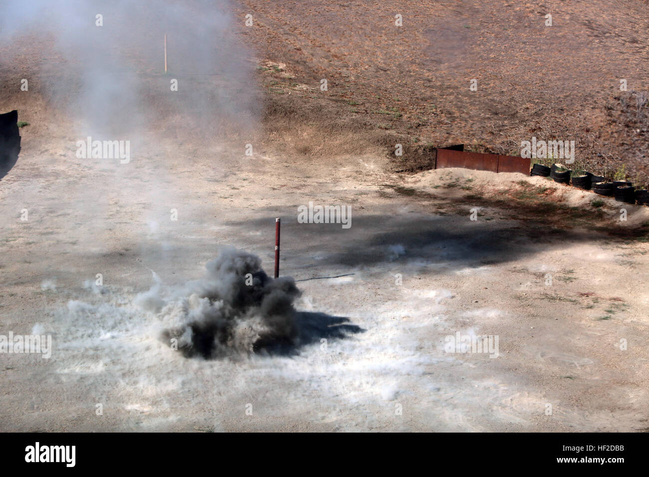 Grenades detonate down range after being thrown by Marines with 9th