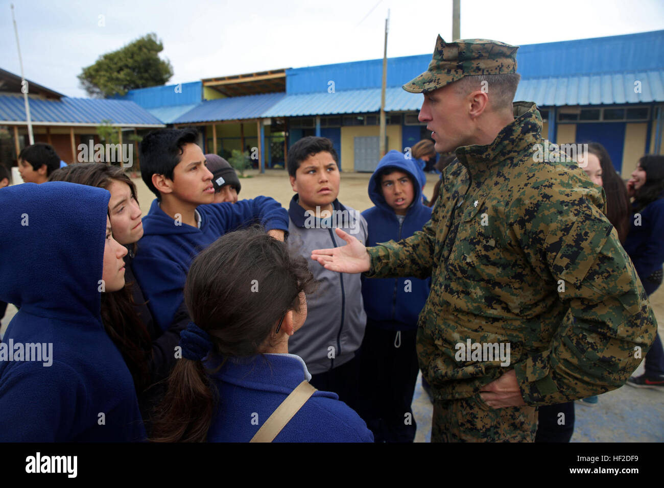 Lt. Col. John R. Lehman II, officer in charge of 4th Civil Affairs Group, speaks with a group of students from Ercole Bencini Primary School in Pichidangui, Chile, during a surprise visit from U.S. Marines Medium Helicopter Squadron 364 out of Marine Corps Air Station Camp Pendleton, California August 14, 2014. The Marines are refurbishing the school's basketball court and repairing the removable soccer goals. The visit took place during a training evolution as part of Partnership of the Americas 2014. Representatives from Argentina, Brazil, Canada, Chile, Colombia, Mexico, Paraguay, and the U Stock Photo