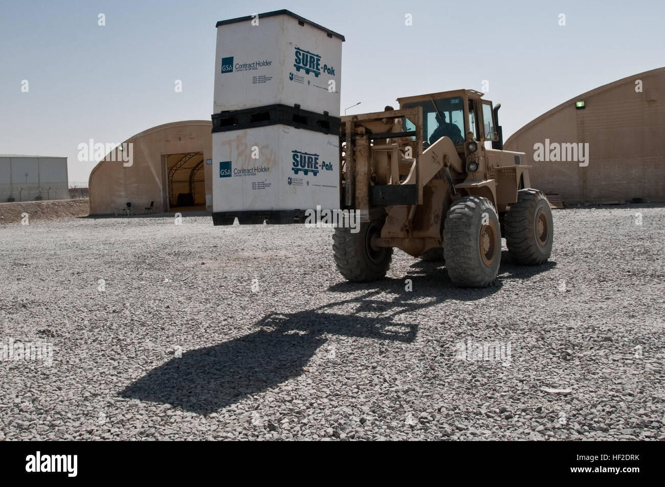 Spc. Johnathon Keeton, a native of Ft. Worth, Texas, who serves with the 354th Medical Logistics Company, 145th Medical Logistics Battalion drives a forklift loaded with containers full of medical supplies to put on a truck on Kandahar Airfield, Afghanistan, Aug. 17, 2014. The supplies were categorized as foreign excess personal property through the U.S. downgrade of medical facilities throughout Regional Command-South and were therefore available to be donated to Mirwais Hospital in Kandahar to help treat locals and Afghan National Security Forces in the region. Excess medical equipment donat Stock Photo
