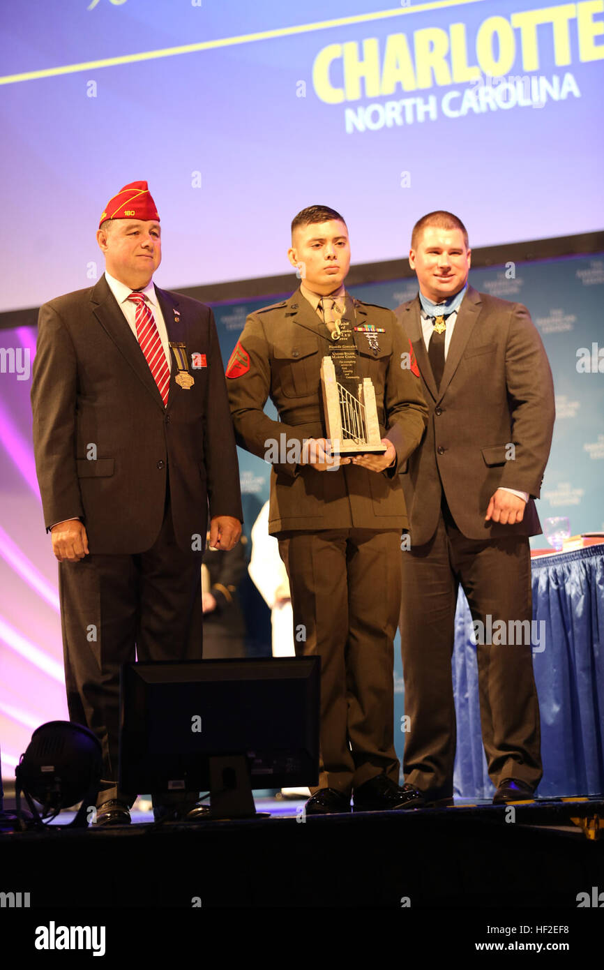 Dan Dellinger, left, Cpl. Ricardo Gonzalez, center, and Army Sgt. Kyle White, stand together during the American Legion’s 96th National Convention in Charlotte, N.C., Aug. 26, 2014. Gonzalez was awarded the Spirit of Service Award for his exceptional contributions to his local community through volunteer efforts off-duty.  Dellinger is the American Legion national commander, Gonzalez is a Marine Air-Ground Task Force planning specialist with 4th Marine Regiment at Camp Schwab, Okinawa, Japan, and White is the 7th living Medal of Honor recipient. Marine awarded American Legion Spirit of Service Stock Photo