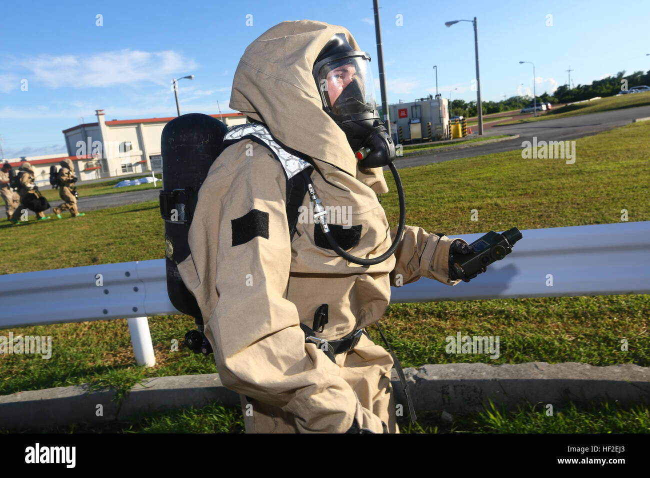 U.S. Marine Corps Lance Cpl. Brittney Williams, with Chemical, Biological, Radiological, and Nuclear Platoon, 1st Marine Aircraft Wing scans the area for any contamination during a simulated training exercise on Marine Corps Air Station Futenma, Okinawa, Japan, Aug. 27, 2014. The exercise was conducted to help marines practice casualty evacuations and decontaminations of individuals in a chemically contaminated environment. (U.S. Marine Corps photo by MCIPAC Combat Camera Lance Cpl. Sergio RamirezRomero/ Released) 1st Marine Aircraft Wing CBRN training 140827-M-FB998-091 Stock Photo