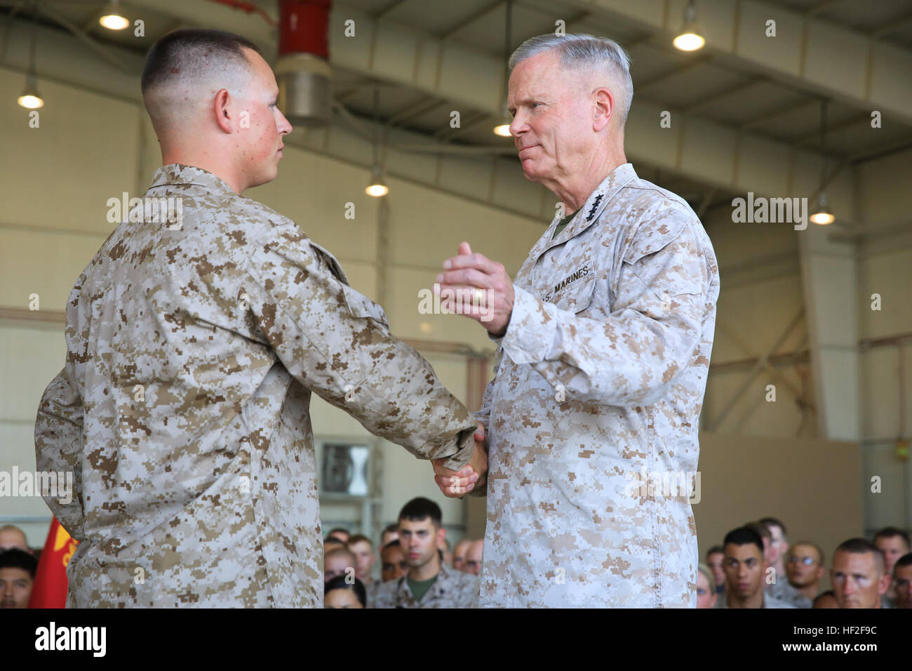 U.S. Marine Corps Gen. James F. Amos, commandant of the Marine Corps, congratulates Cpl. Matthew Padilla, an airframe mechanic assigned to Marine Aviation Logistics Group 17 (MALS-17), Marine Aircraft Group – Afghanistan (MAG-A), after promoting him meritoriously during a visit to forward deployed forces aboard Camp Bastion, Helmand province, Afghanistan, Sept 6, 2014. The visit marks the final time Amos and Sgt. Maj. Micheal P. Barrett, sergeant major of the Marine Corps, will meet with Marines and sailors deployed to Helmand in support of Operation Enduring Freedom. (Official U.S. Marine Cor Stock Photo