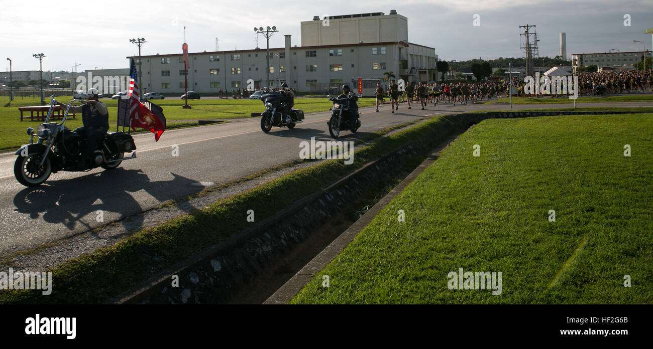 Members of the Okinawa Riding Club lead the running route for the Prisoner of War/Missing in Action 5k Remembrance Run Sept. 19 on Camp Hansen. This is the first year the motorcyclists participated in the event. “We hope they come back next year,” said Nathan Hill, from Belmont, Iowa, and a Marine Corps Community Service Okinawa sports specialist. “This was a great addition to the run.” (U.S. Marine Corps photo by Lance Cpl. Devon Tindle/Released) A Run to Remember, Marines gather for POW-MIA recognition day 140919-M-XW268-025 Stock Photo